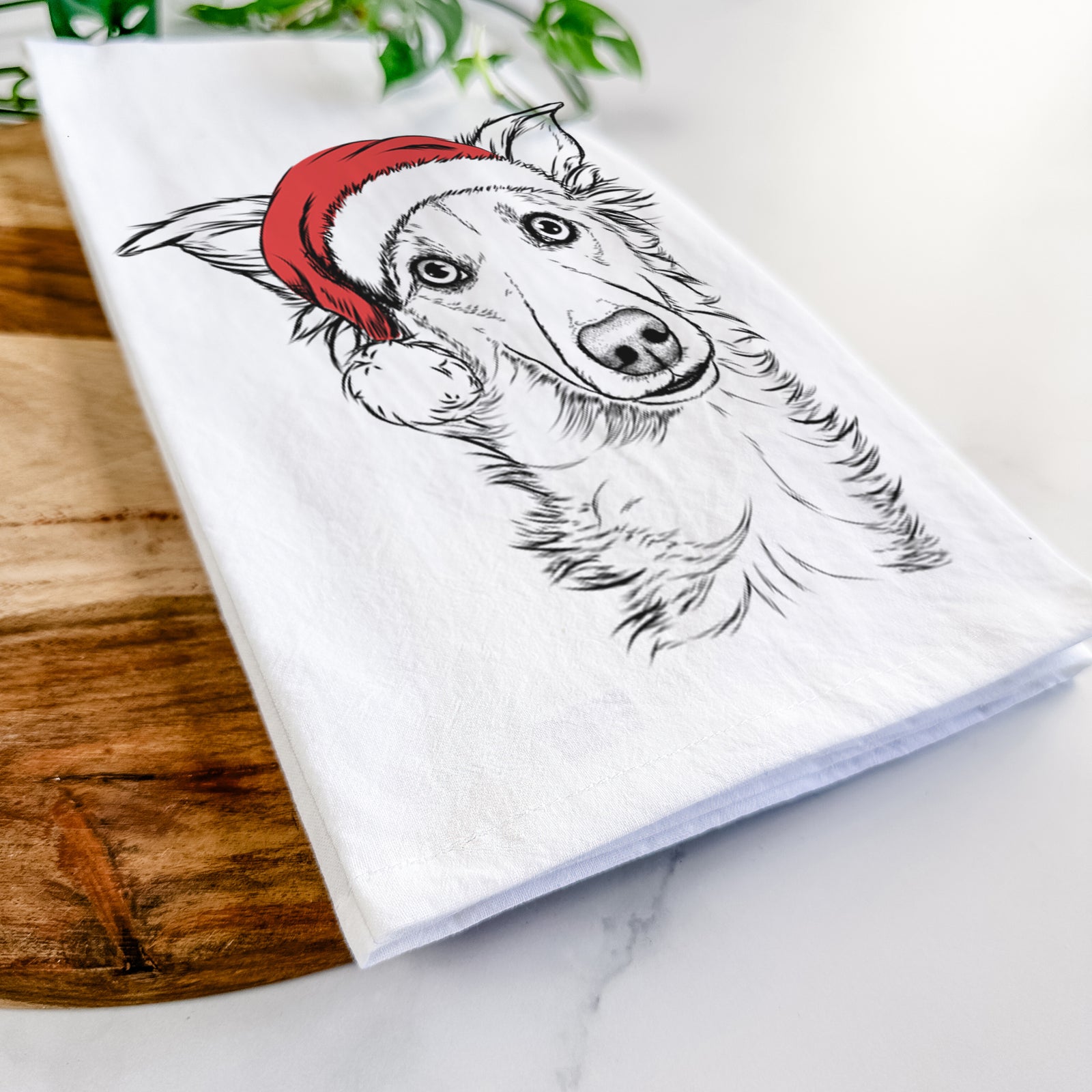 Hand-drawn sketch of Kyu the Windsprite wearing a Santa hat on a tea towel