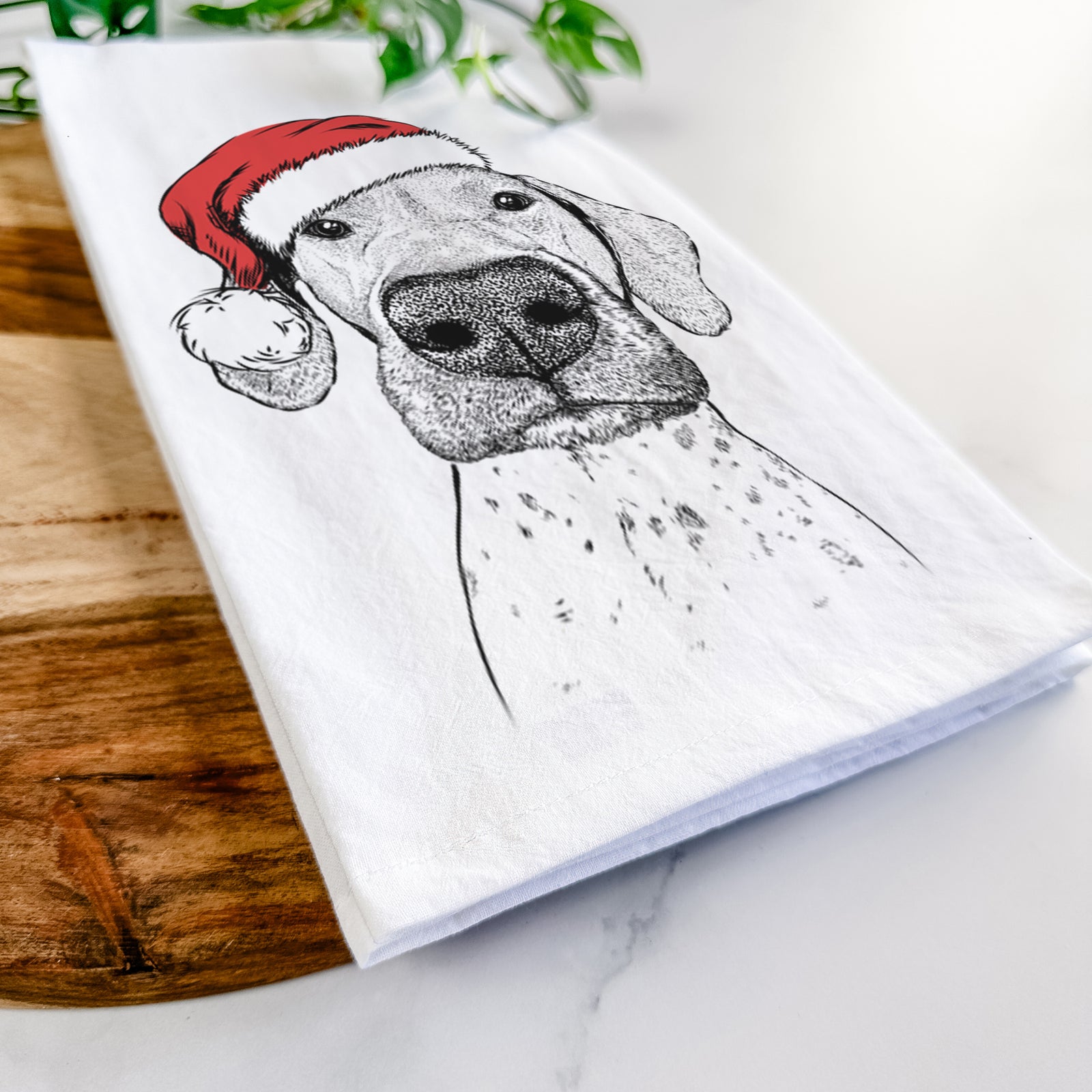 Hand-drawn sketch of Leroy the German Shorthaired Pointer wearing a Santa hat on a tea towel