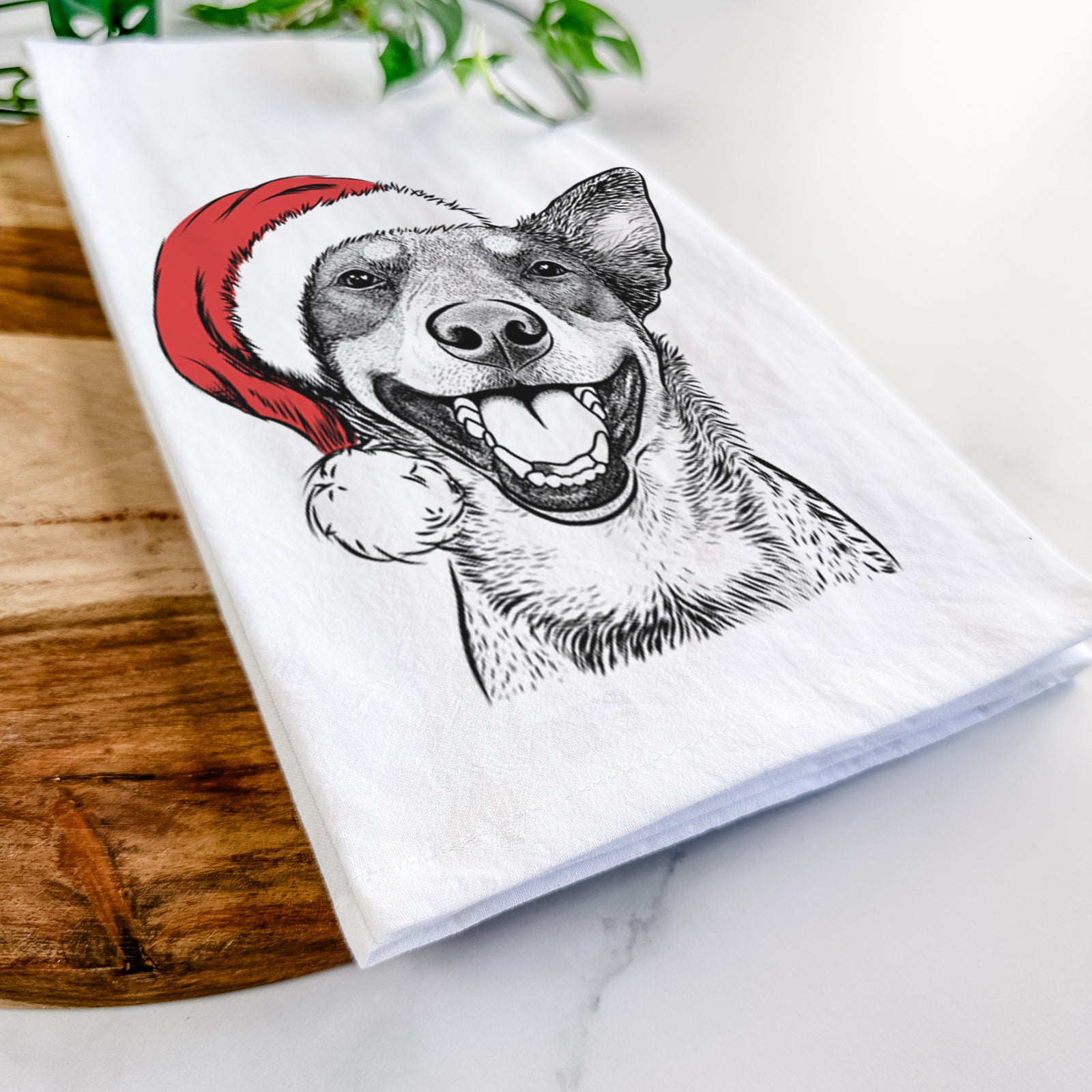 Hand-drawn sketch of Lily the Australian Cattle Dog wearing a Santa hat on a tea towel