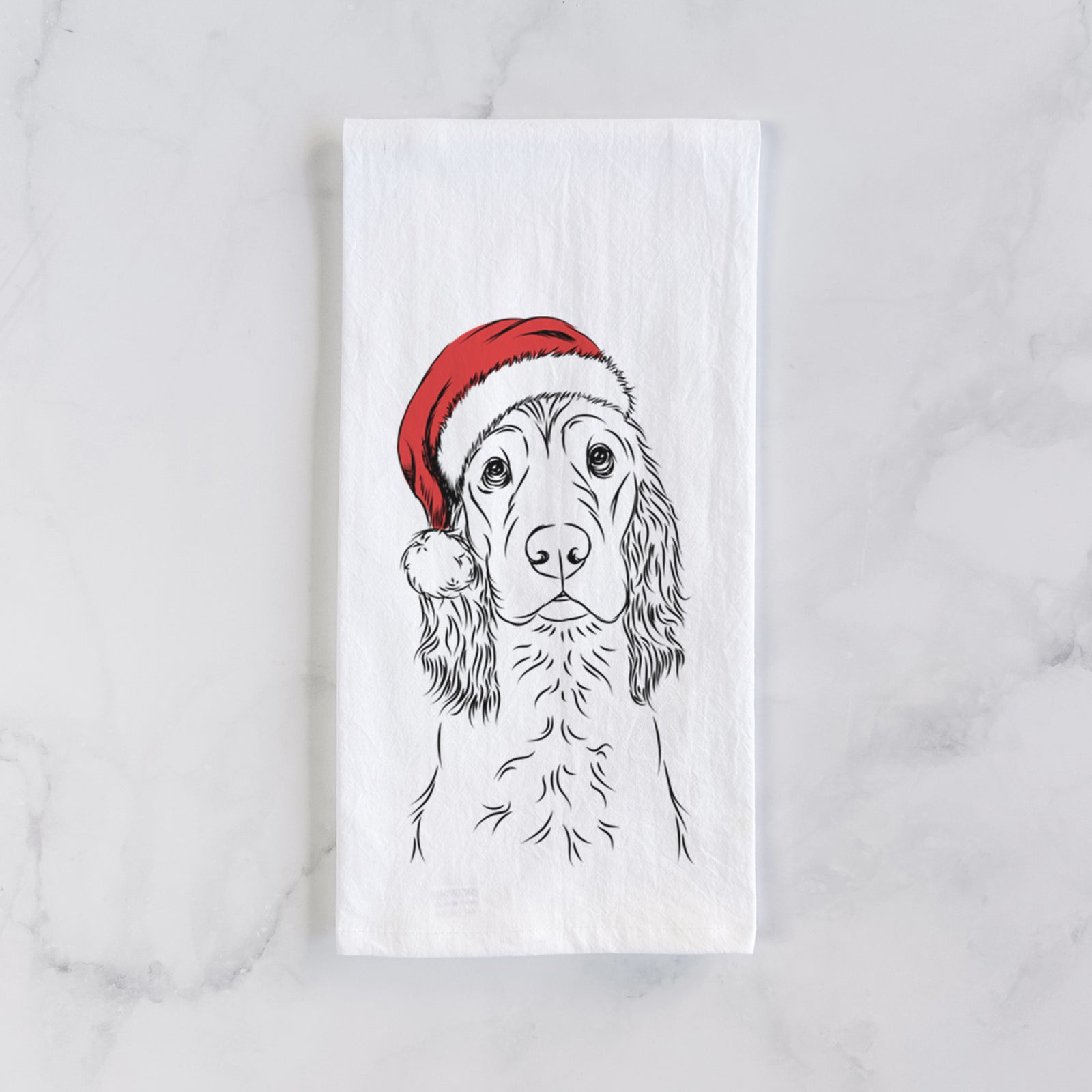 Hand-drawn sketch of Logan the Cocker Spaniel wearing a Santa hat on a tea towel
