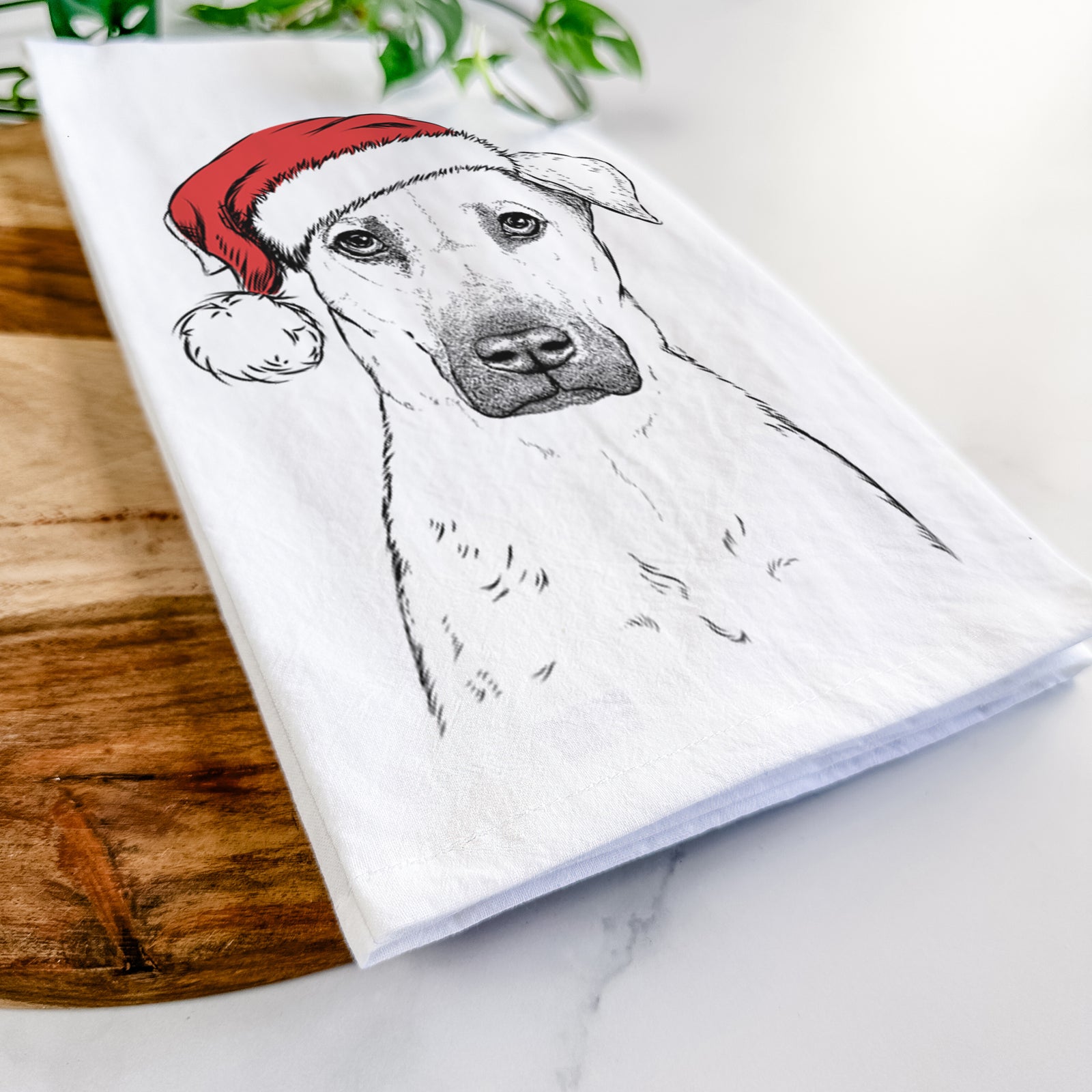 Hand-drawn sketch of Luna the Black Mouth Cur wearing a Santa hat on a tea towel