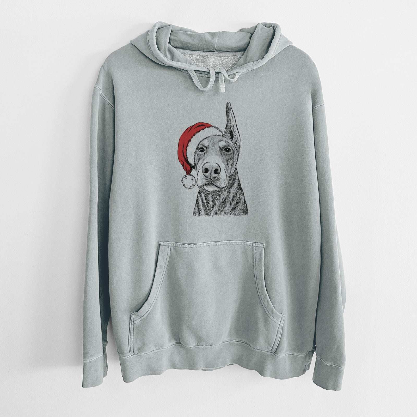 Hand-drawn sketch of Luna the Doberman Pinscher wearing a Santa hat on a Sage Unisex pigment dyed hoodie