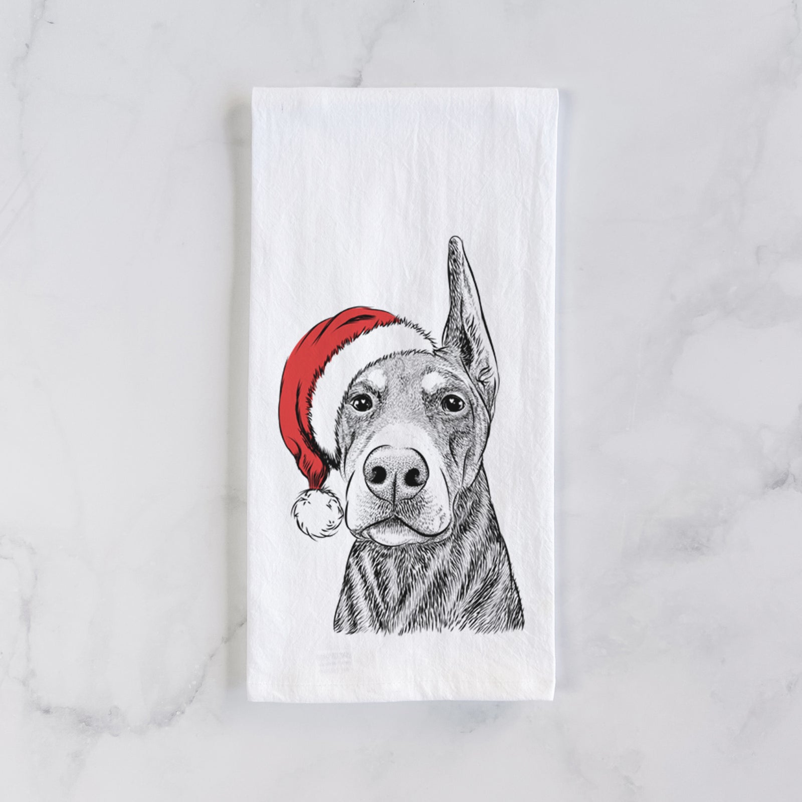 Hand-drawn sketch of Luna the Doberman Pinscher wearing a Santa hat on a tea towel