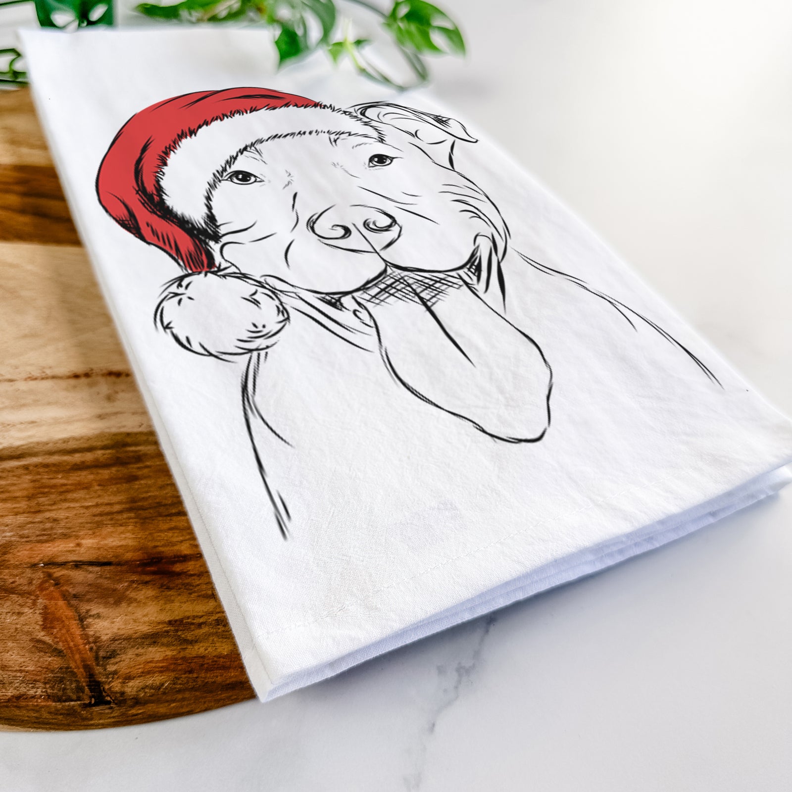 Hand-drawn sketch of Major the Pitbull wearing a Santa hat on a tea towel