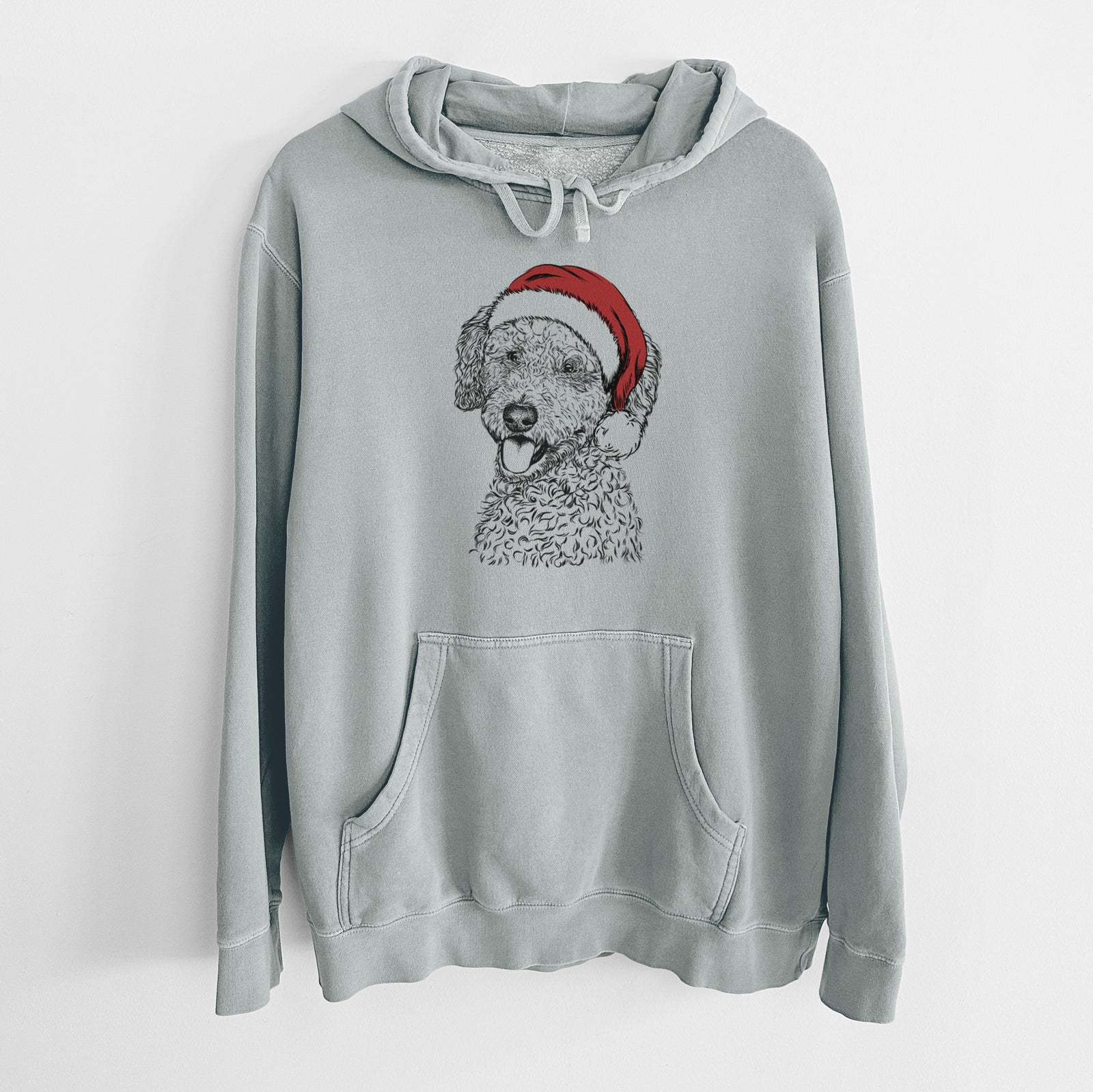 Hand-drawn sketch of Marlow the Goldendoodle wearing a Santa hat on a Sage Unisex pigment dyed hoodie