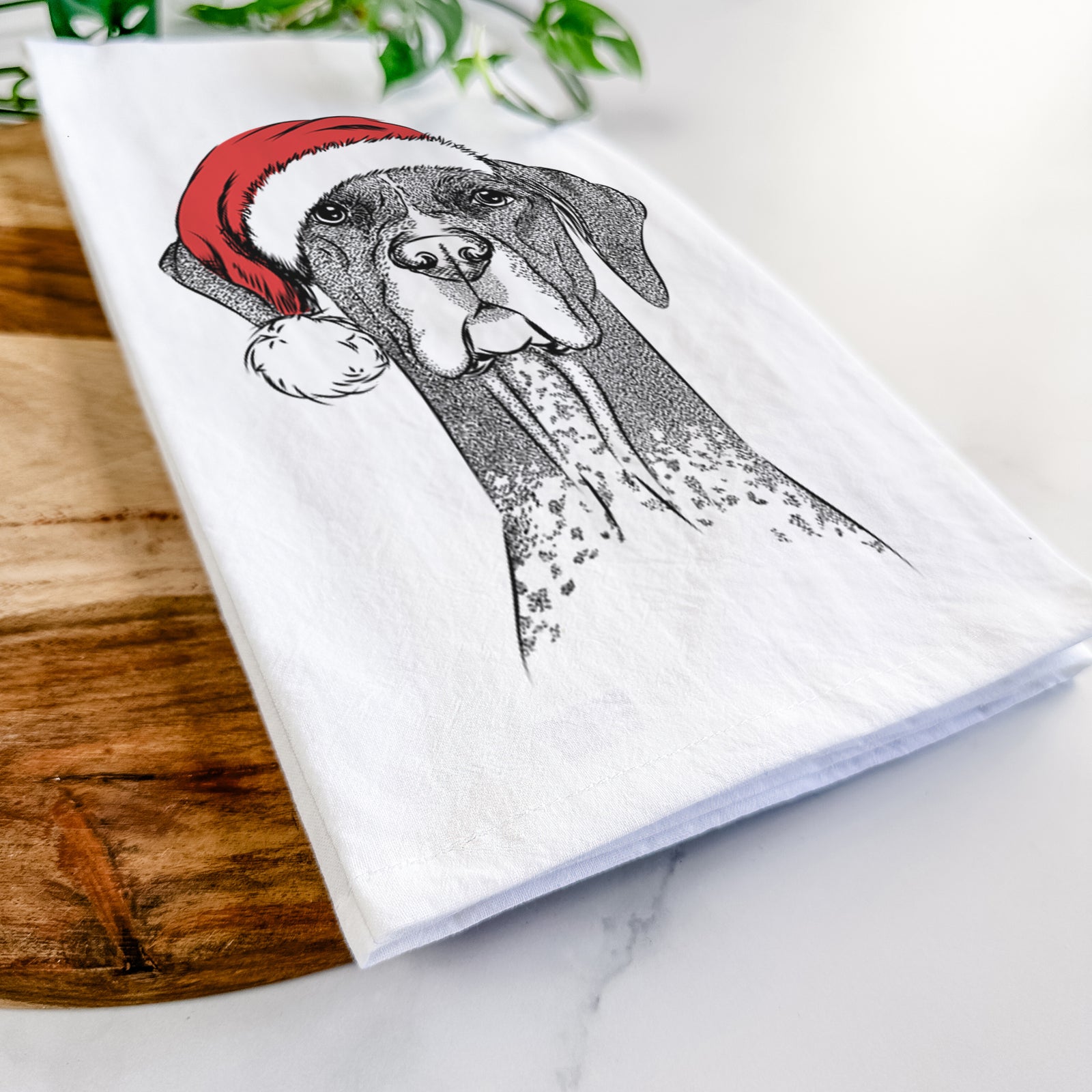Hand-drawn sketch of Mattis the German Shorthaired Pointer wearing a Santa hat on a tea towel