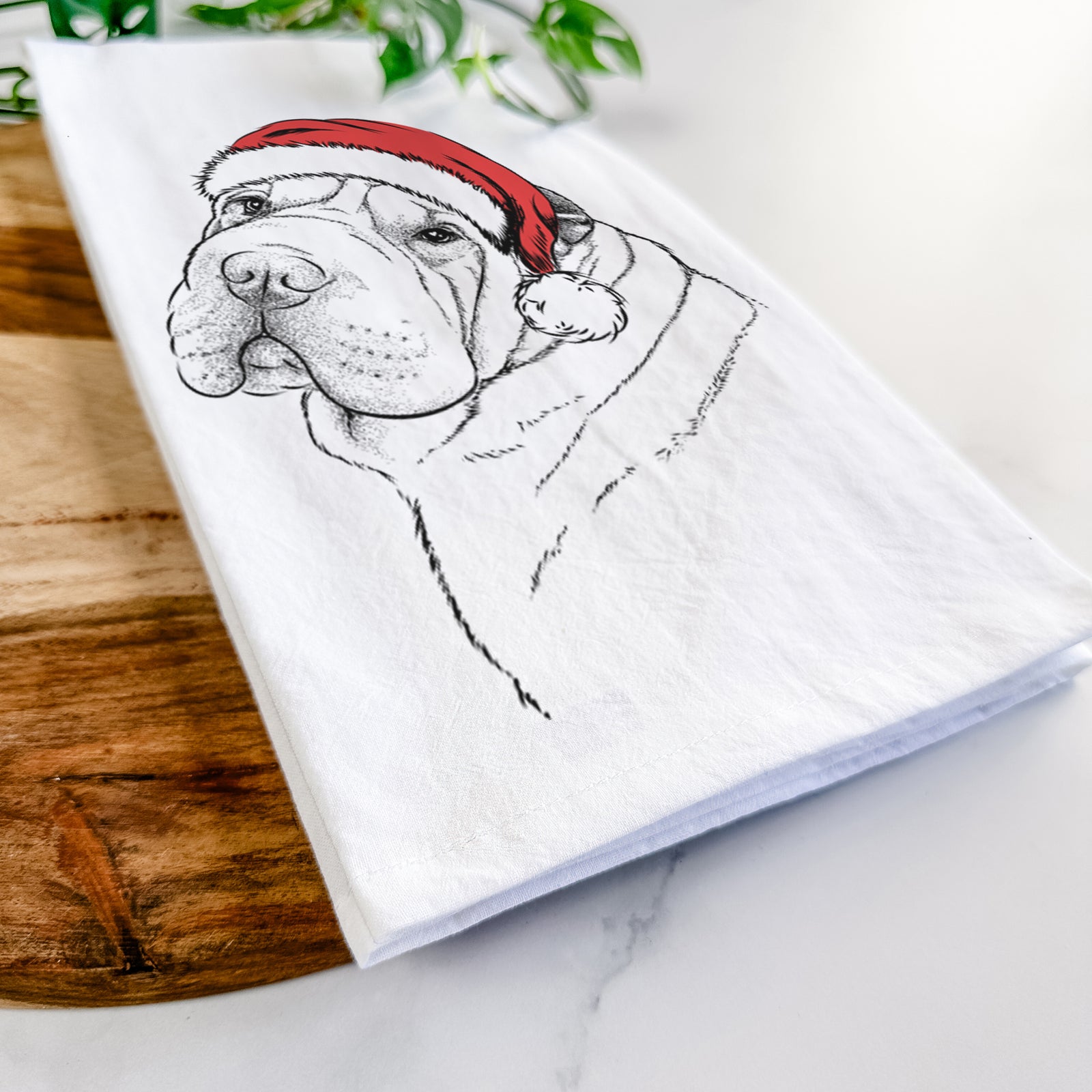 Hand-drawn sketch of Maximus the Shar Pei wearing a Santa hat on a tea towel