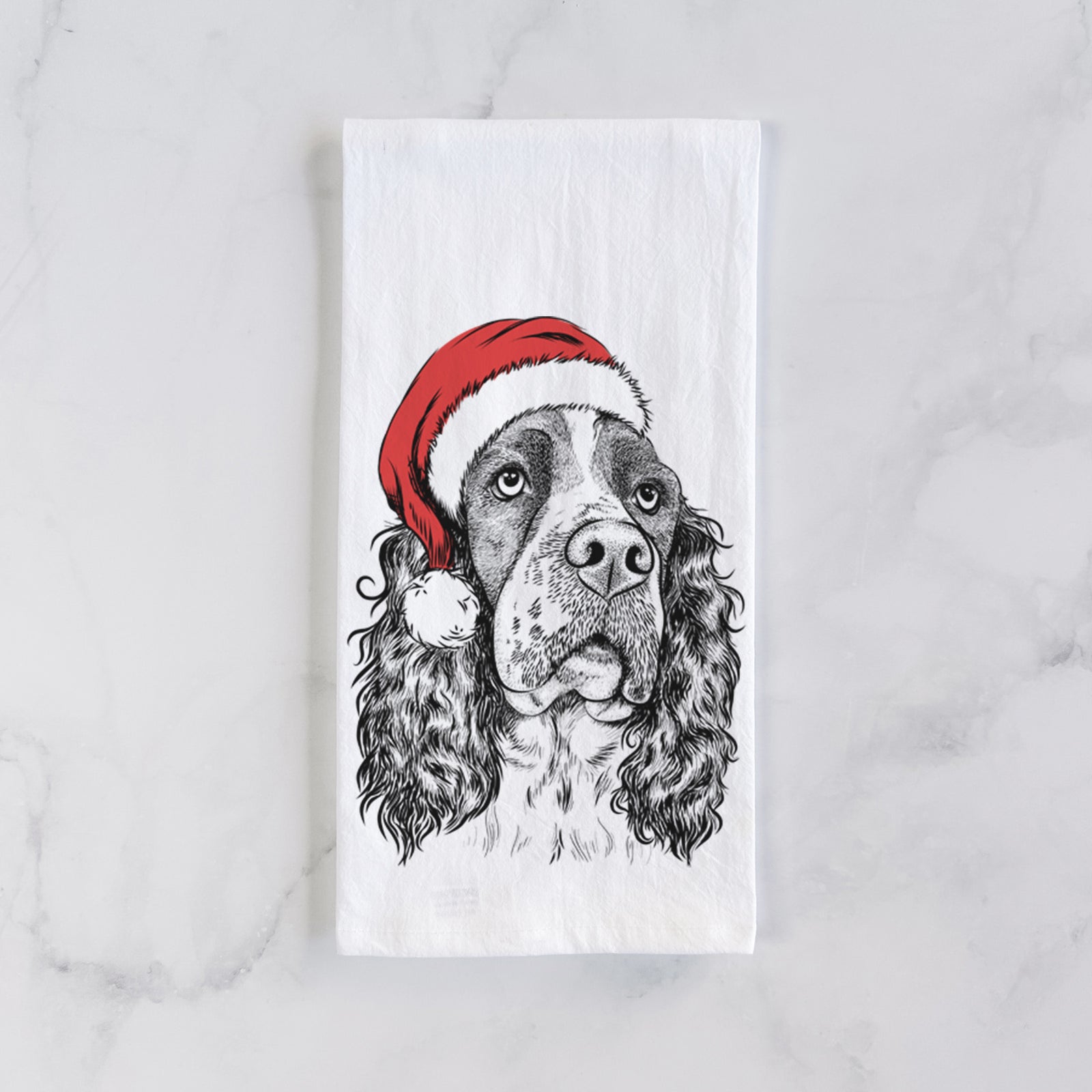 Hand-drawn sketch of Millie Mae the English Springer Spaniel wearing a Santa hat on a tea towel