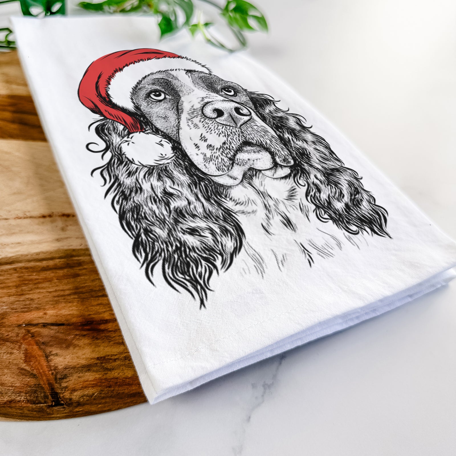 Hand-drawn sketch of Millie Mae the English Springer Spaniel wearing a Santa hat on a tea towel