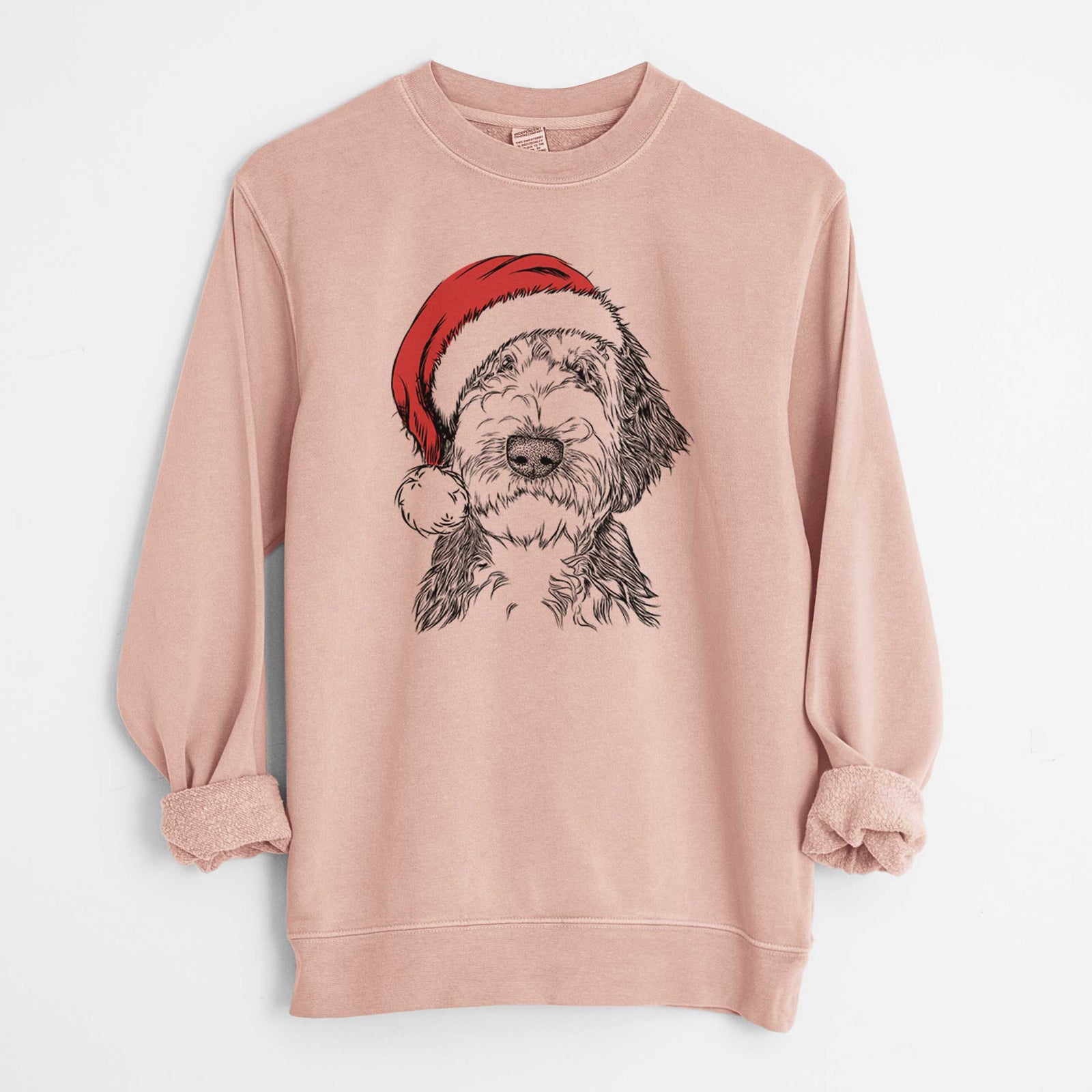 Hand-drawn sketch of Milo Fluff the Sheepadoodle wearing a Santa hat on a Dusty Pink Unisex pigment dyed crew sweatshirt