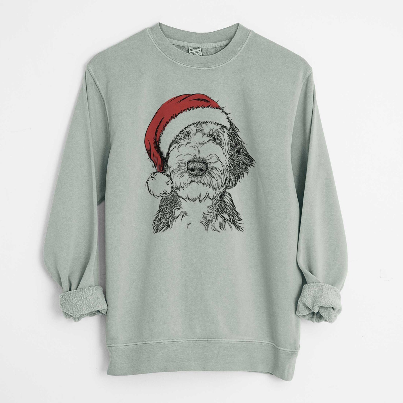 Hand-drawn sketch of Milo Fluff the Sheepadoodle wearing a Santa hat on a Sage Unisex pigment dyed crew sweatshirt