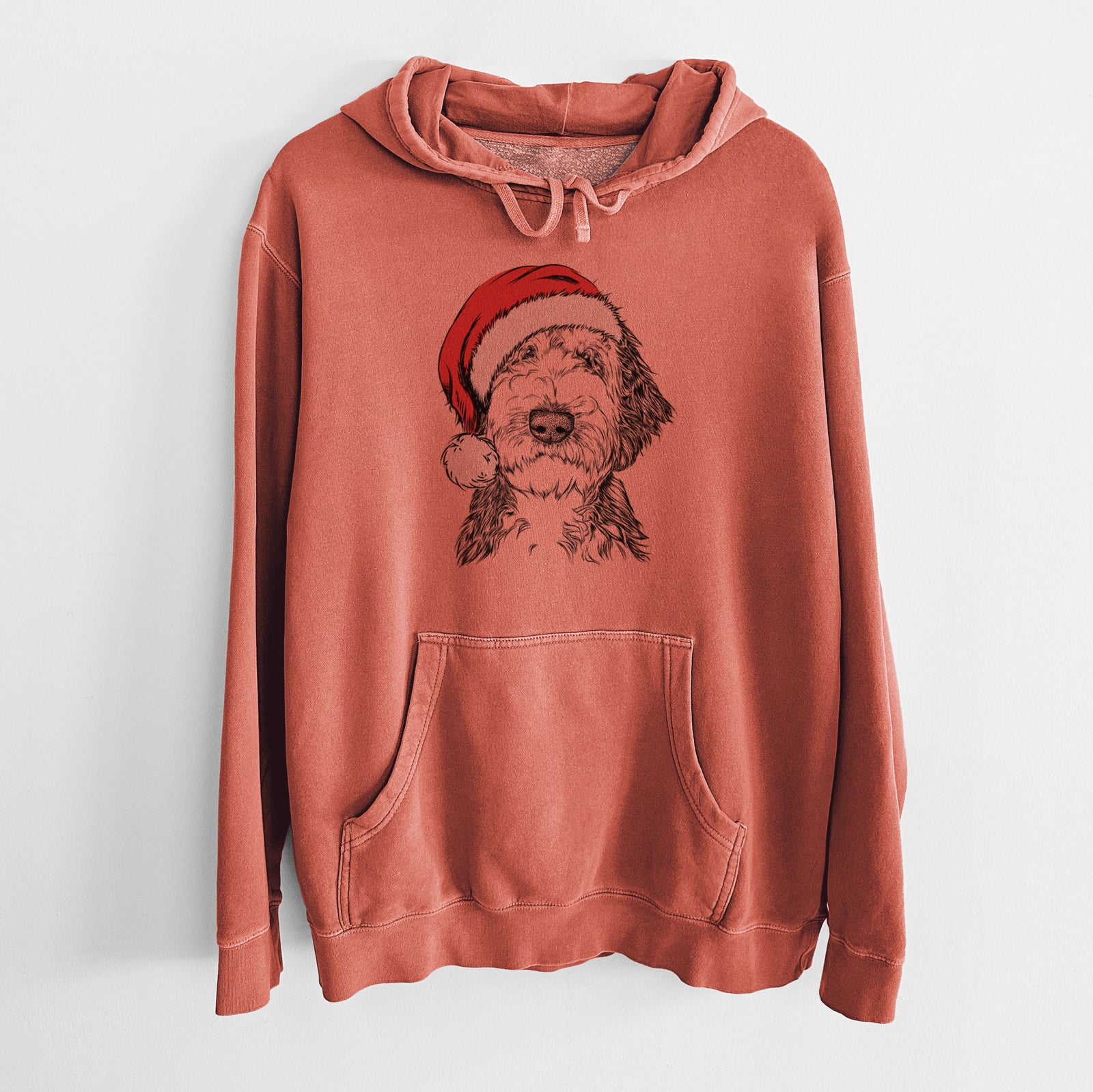 Hand-drawn sketch of Milo Fluff the Sheepadoodle wearing a Santa hat on an Amber Unisex pigment dyed hoodie