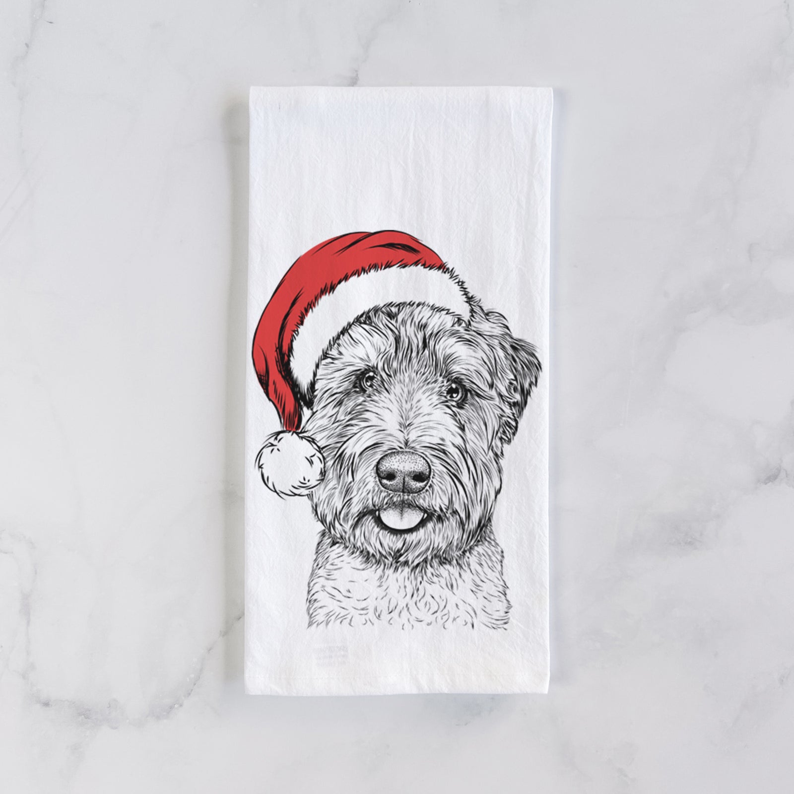 Hand-drawn sketch of Milton the Soft Coated Wheaten Terrier wearing a Santa hat on a tea towel