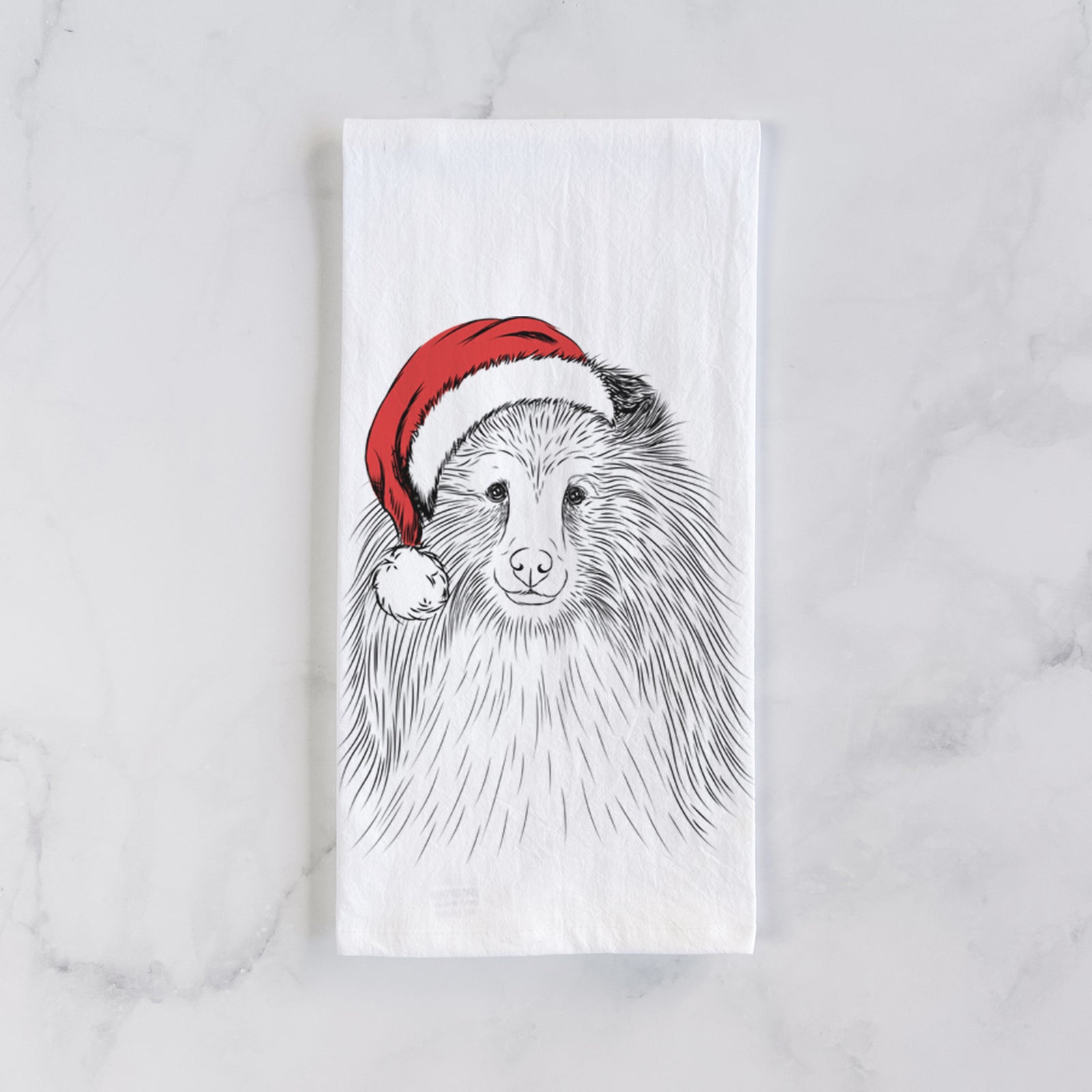 Hand-drawn sketch of Moxie the Shetland Sheepdog wearing a Santa hat on a tea towel