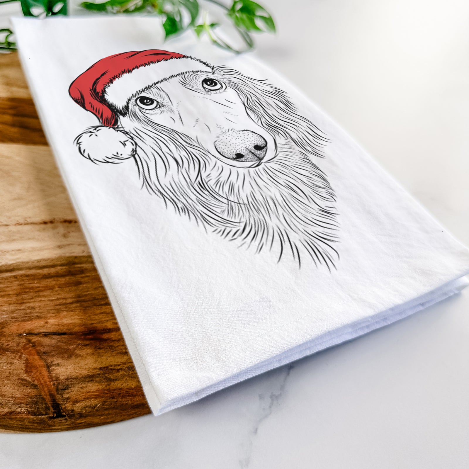 Hand-drawn sketch of Mr. Rusty the Long Haired Dachshund wearing a Santa hat on a tea towel