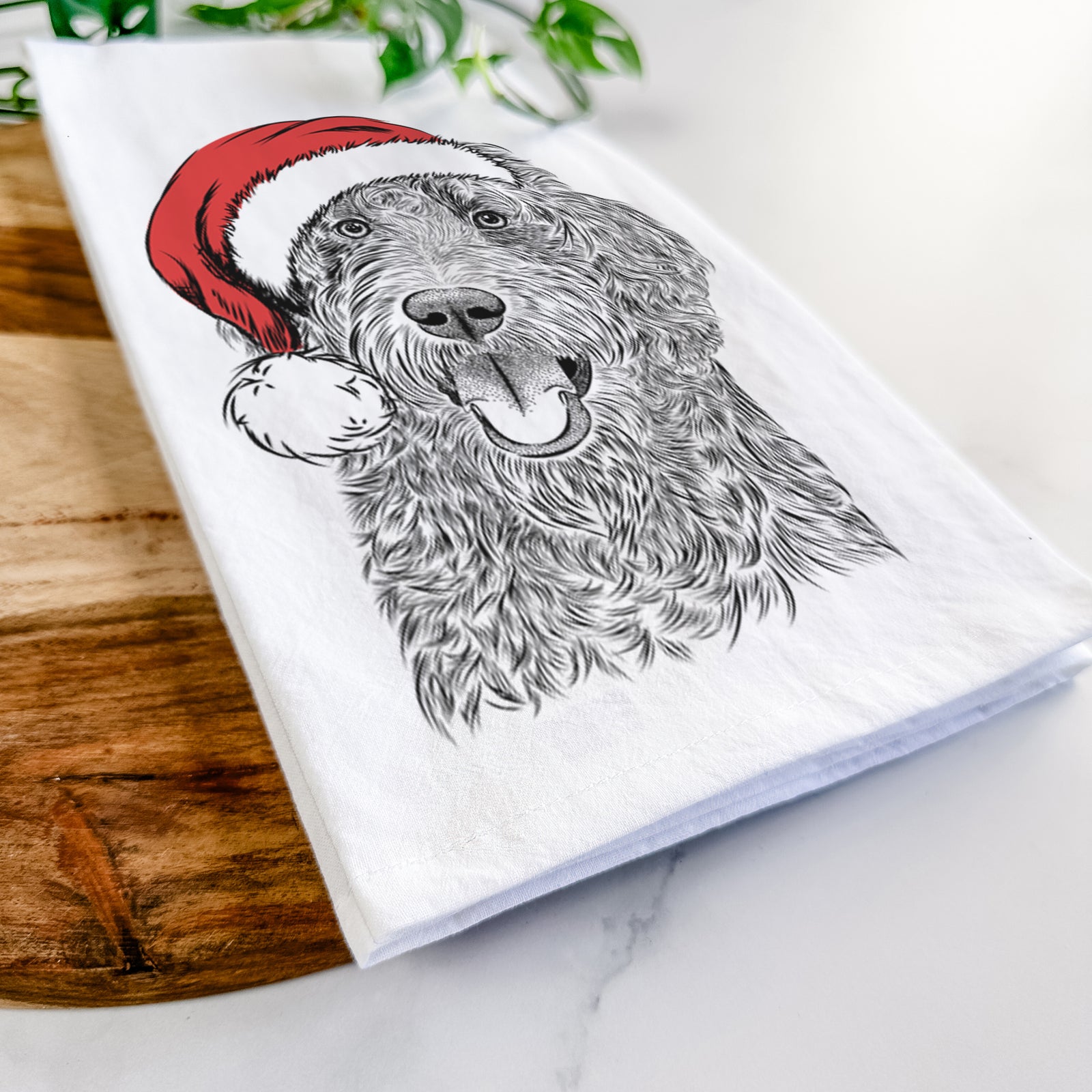 Hand-drawn sketch of Murr Dog the Labradoodle wearing a Santa hat on a tea towel