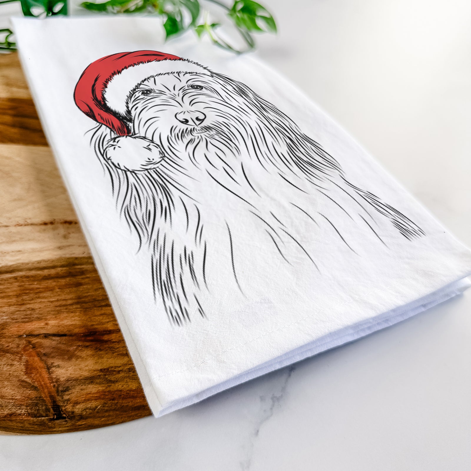 Hand-drawn sketch of Murray the Bearded Collie wearing a Santa hat on a tea towel
