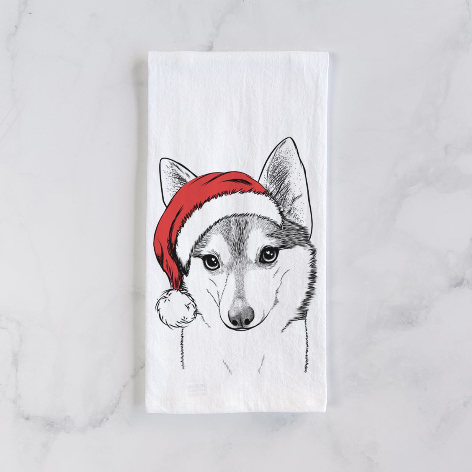 Hand-drawn sketch of Nami the Alaskan Klee Kai wearing a Santa hat on a tea towel