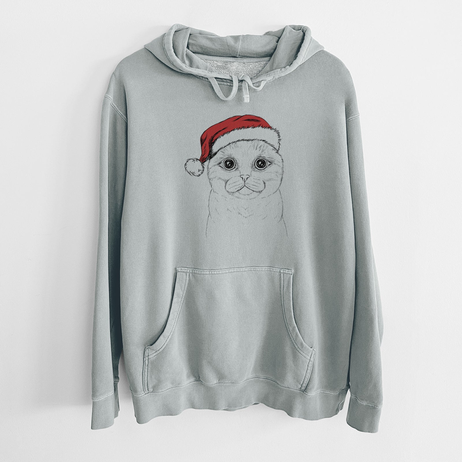 Hand-drawn sketch of Neko the Scottish Fold Cat wearing a Santa hat on a Sage Unisex pigment dyed hoodie