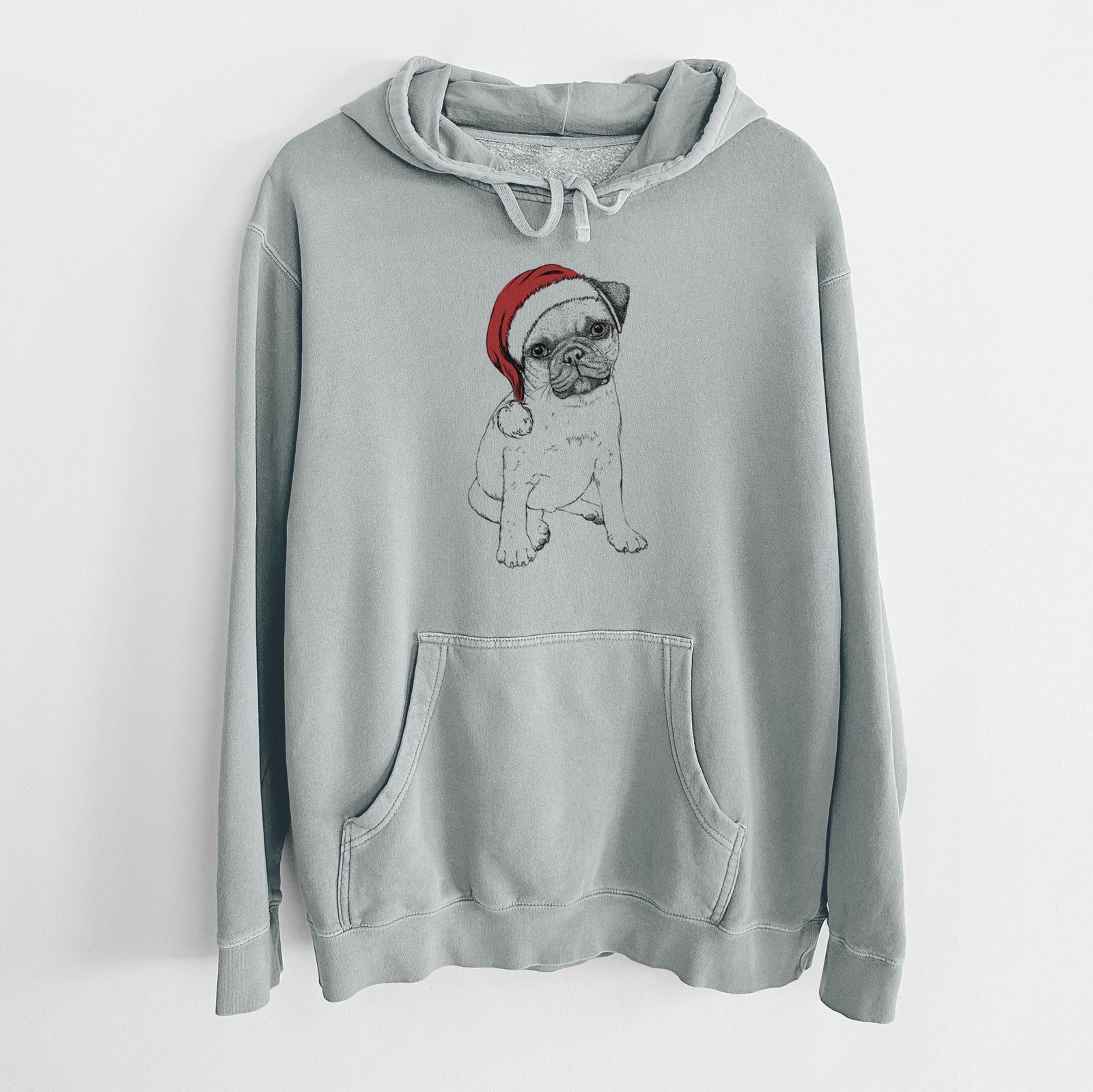Hand-drawn sketch of Nelson the Pug Puppy wearing a Santa hat on a Sage Unisex pigment dyed hoodie