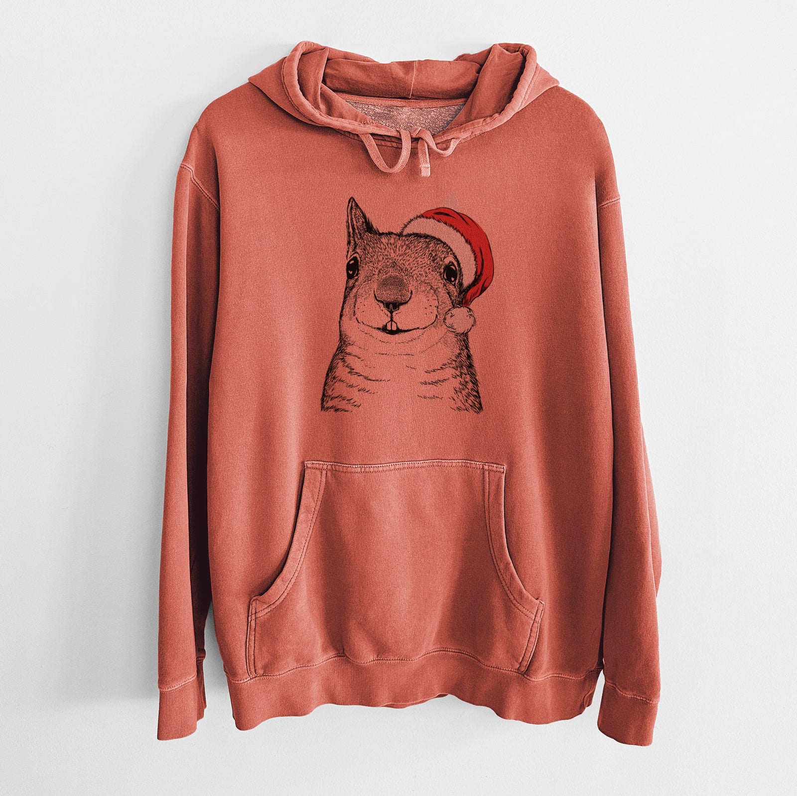 Hand-drawn sketch of Nibbles the Squirrel wearing a Santa hat on an Amber Unisex pigment dyed hoodie