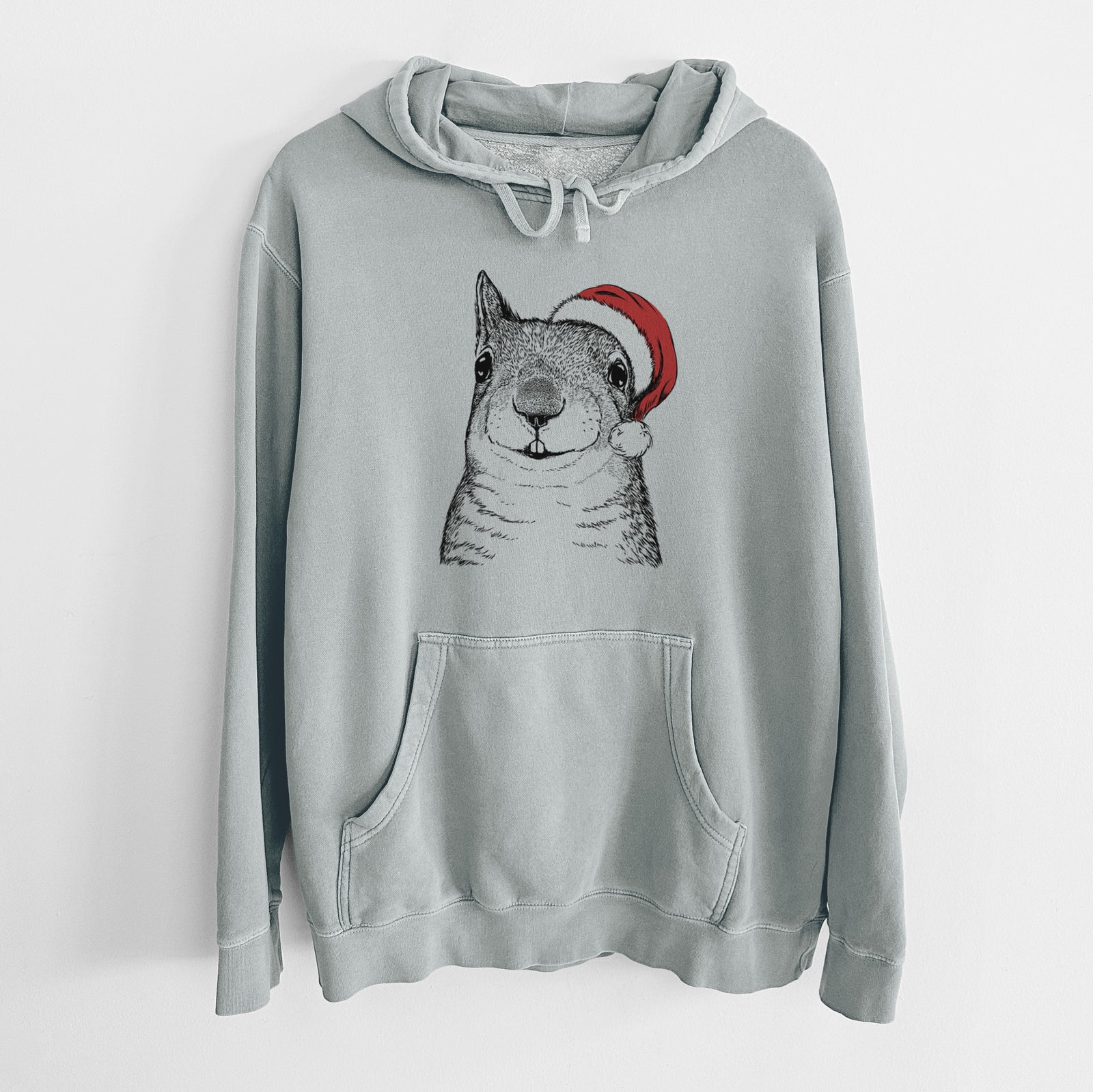 Hand-drawn sketch of Nibbles the Squirrel wearing a Santa hat on a Sage Unisex pigment dyed hoodie
