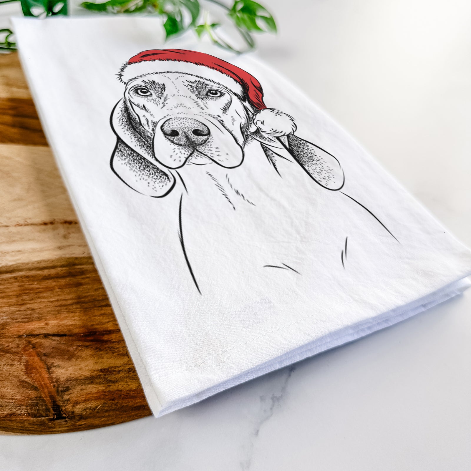 Hand-drawn sketch of Norman the Plott Hound wearing a Santa hat on a tea towel