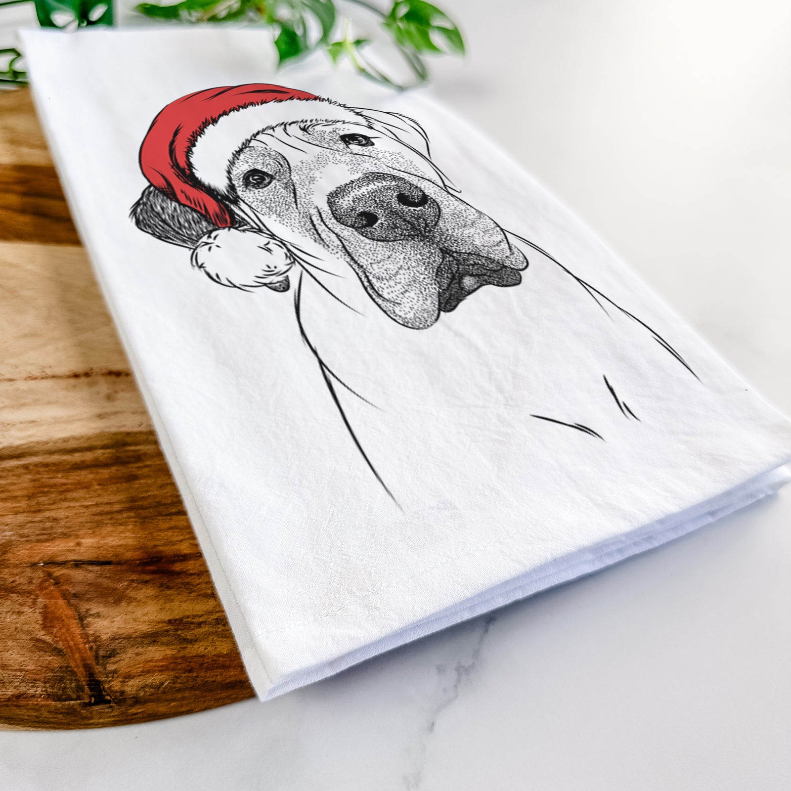 Hand-drawn sketch of Nutterbutter the English Mastiff wearing a Santa hat on a tea towel