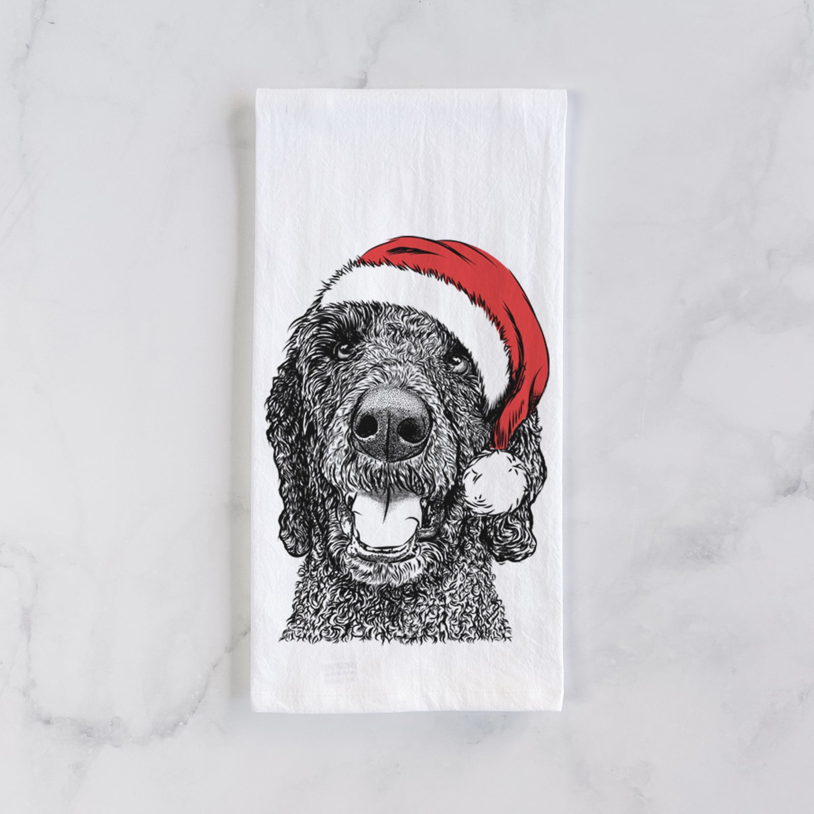Hand-drawn sketch of Obi James the Goldendoodle wearing a Santa hat on a tea towel