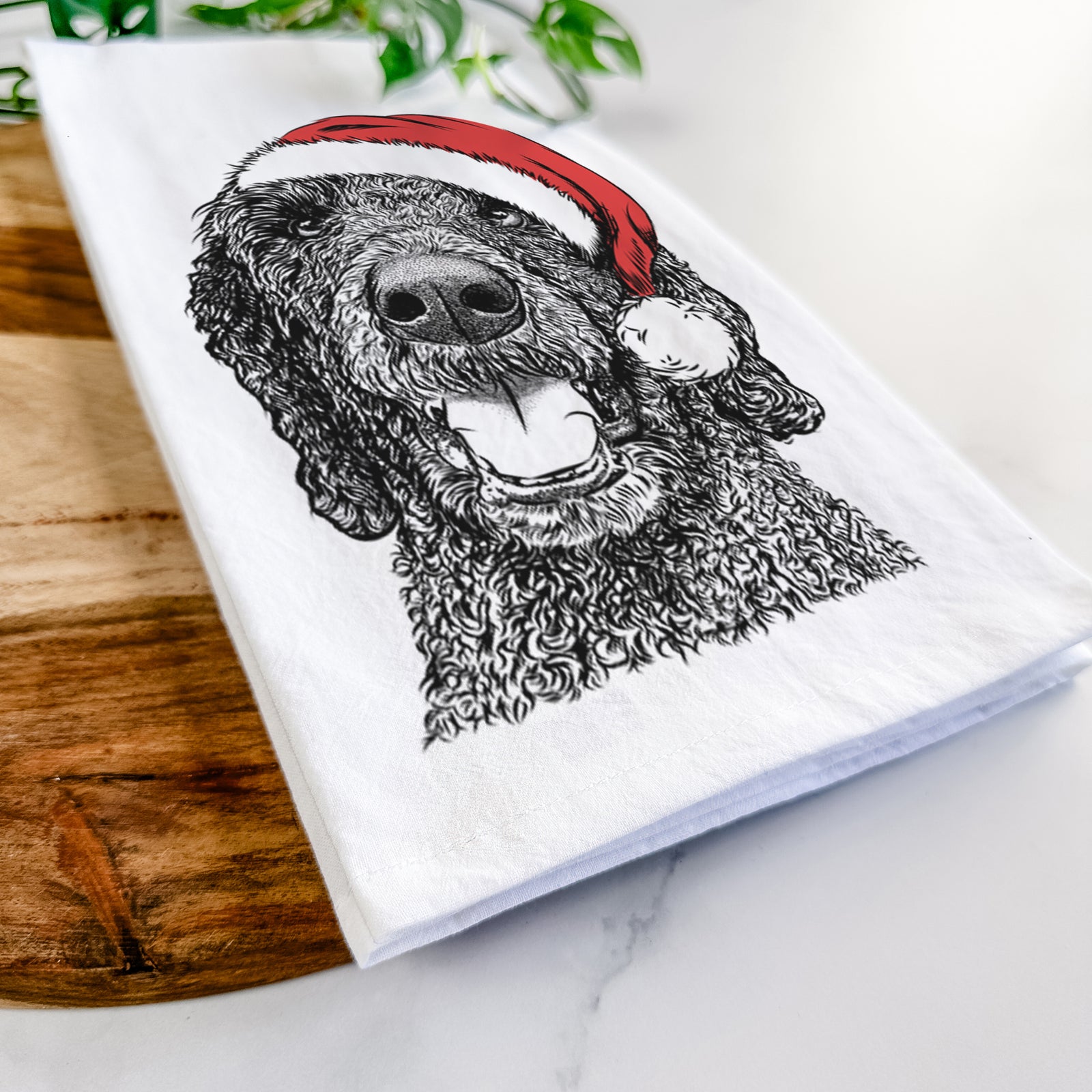 Hand-drawn sketch of Obi James the Goldendoodle wearing a Santa hat on a tea towel