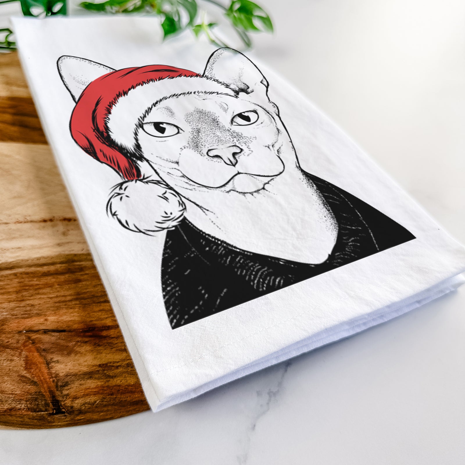 Hand-drawn sketch of Oliver Watson the Sphynx Cat wearing a Santa hat on a tea towel