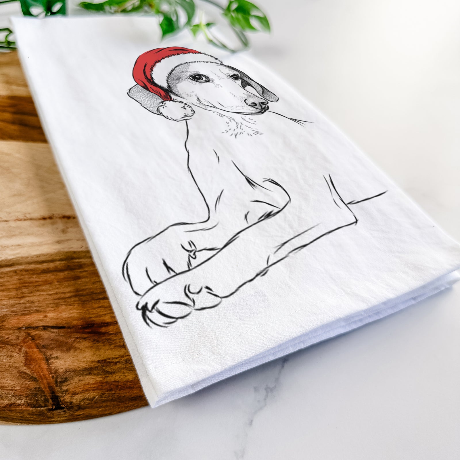 Hand-drawn sketch of Opie the Foxhound wearing a Santa hat on a tea towel