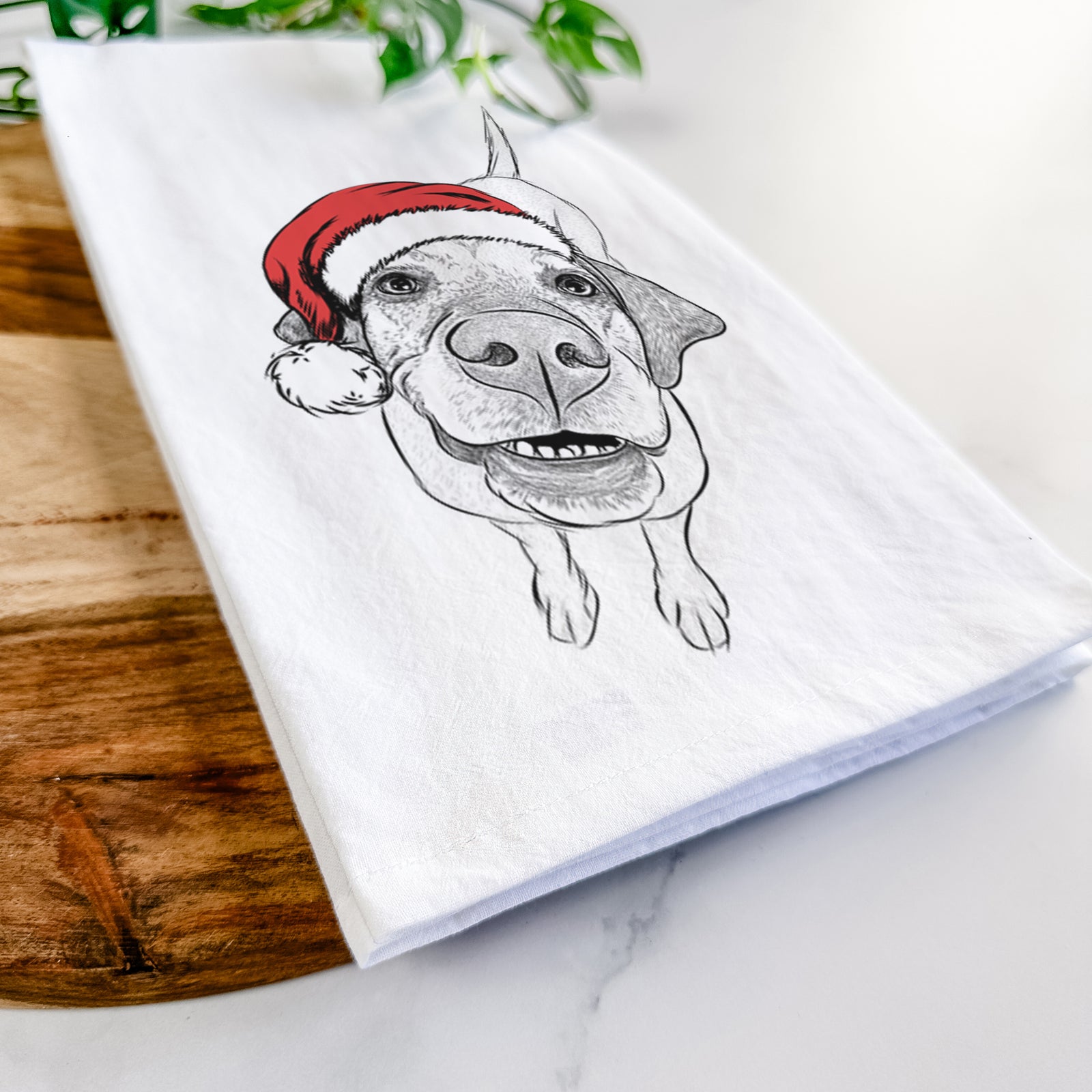 Hand-drawn sketch of Oquirrh the Vizsla wearing a Santa hat on a tea towel
