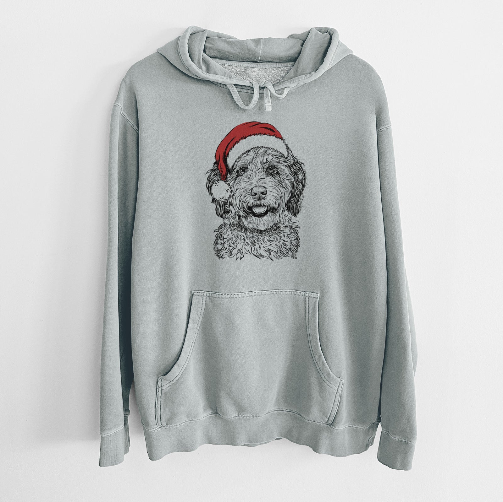 Hand-drawn sketch of Palmer the Aussiedoodle wearing a Santa hat on a Sage Unisex pigment dyed hoodie