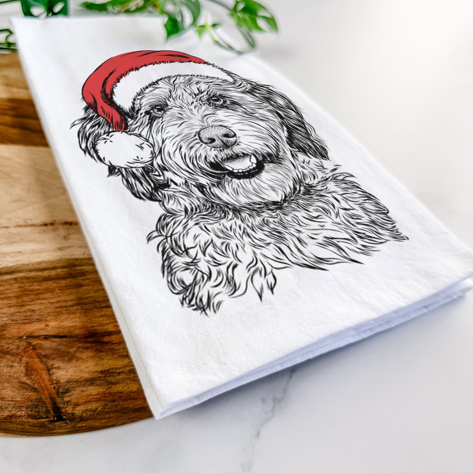 Hand-drawn sketch of Palmer the Aussiedoodle wearing a Santa hat on a tea towel