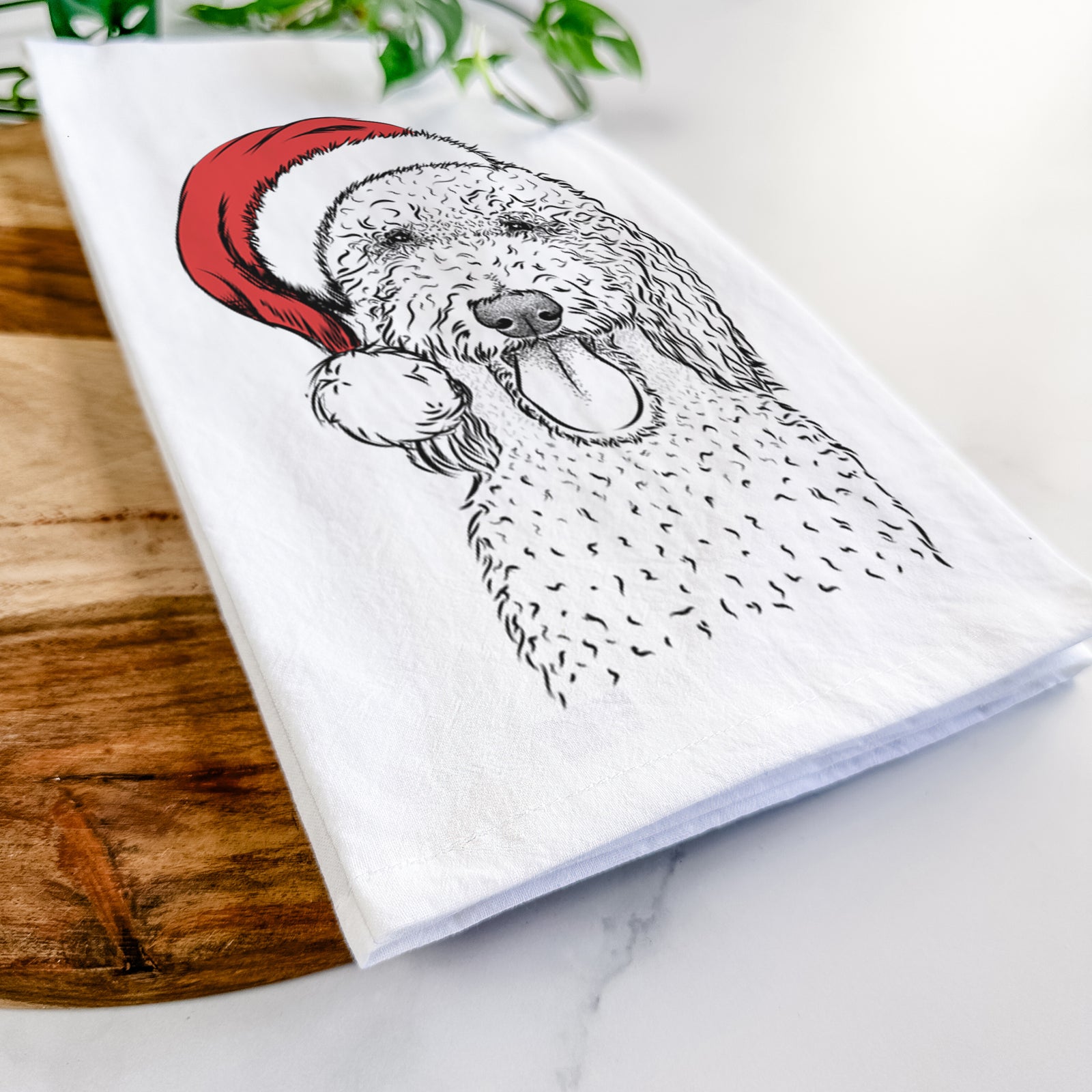 Hand-drawn sketch of Pavlov the Goldendoodle wearing a Santa hat on a tea towel