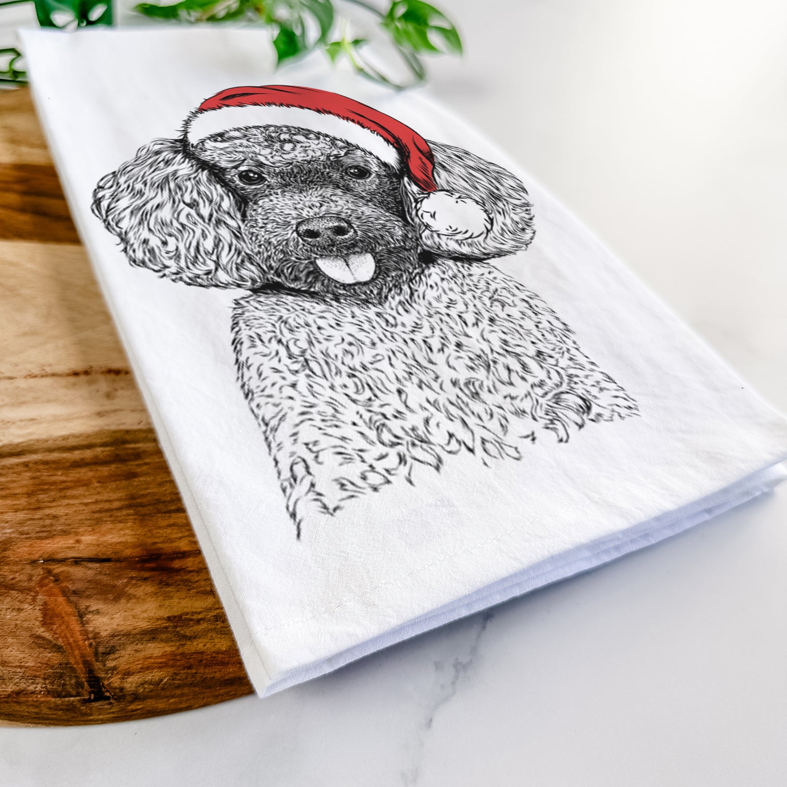 Hand-drawn sketch of George the Toy Poodle wearing a Santa hat on a tea towel