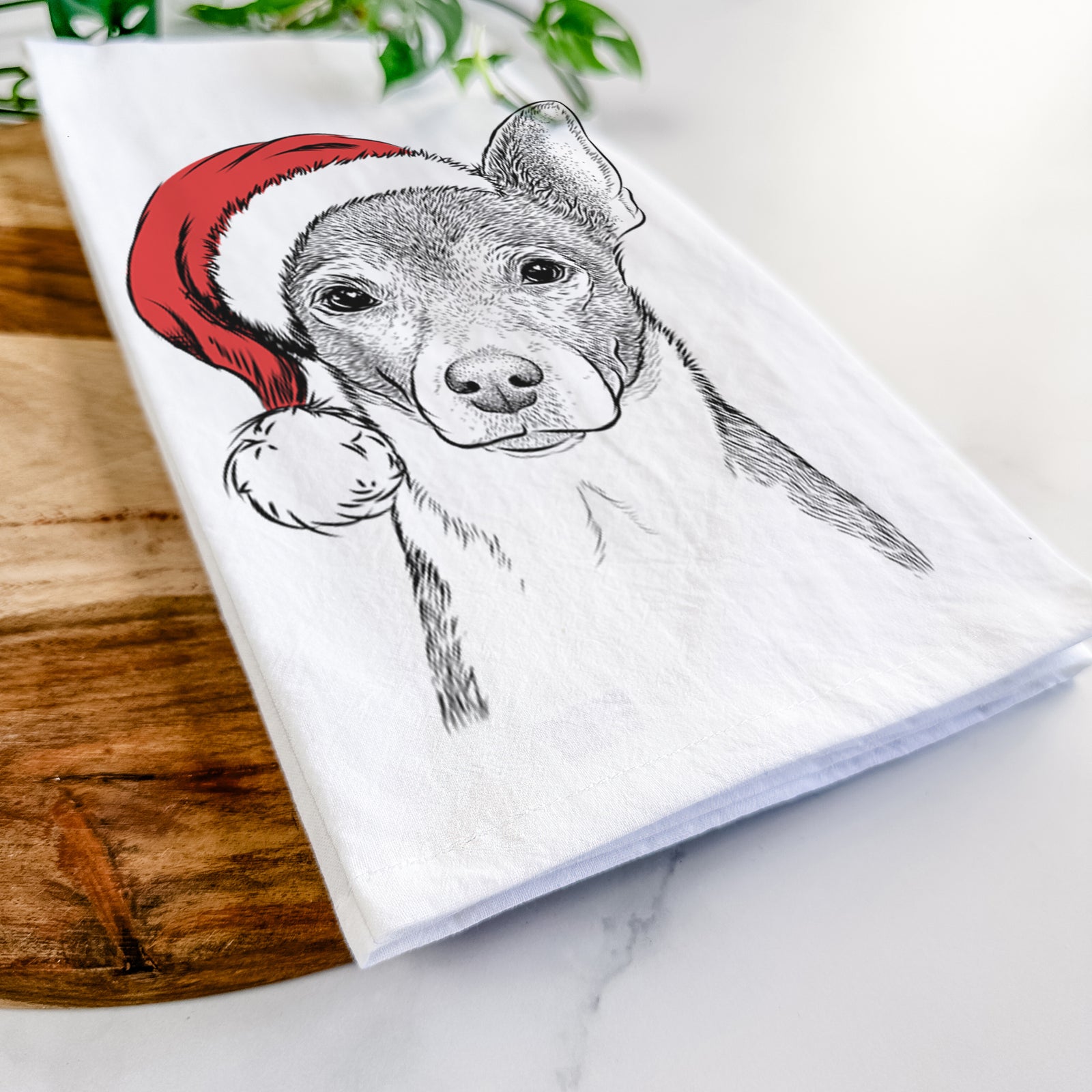 Hand-drawn sketch of Peanut the Chihuahua wearing a Santa hat on a tea towel