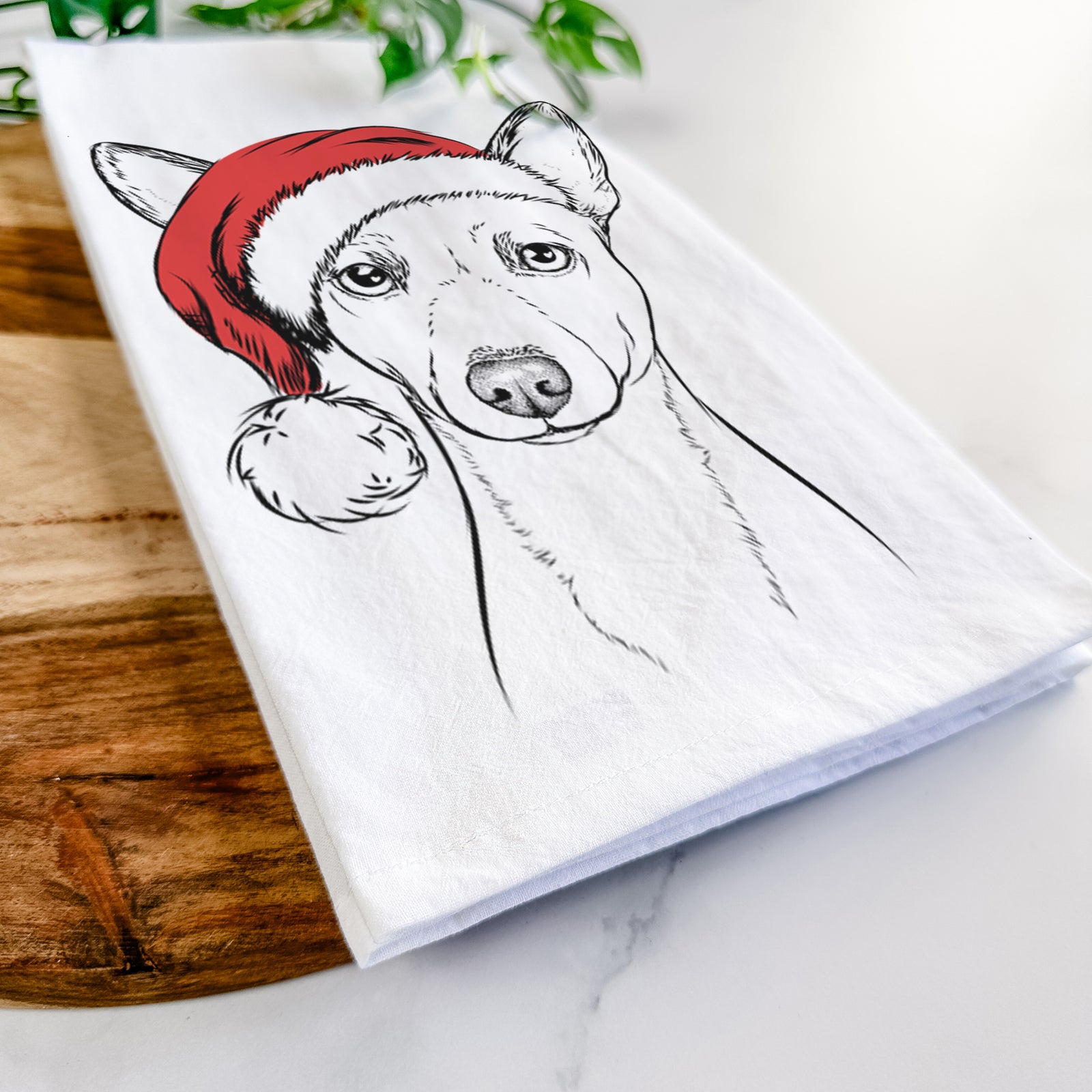 Hand-drawn sketch of Perry the Portuguese Podengo wearing a Santa hat on a tea towel