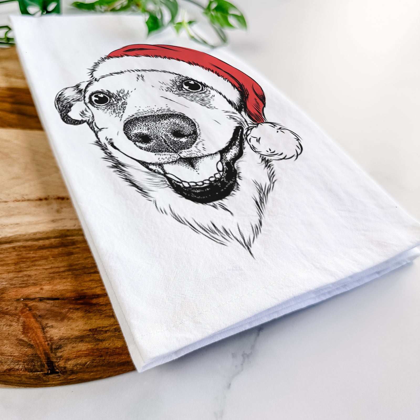 Hand-drawn sketch of Petrah the Staffy Mix wearing a Santa hat on a tea towel