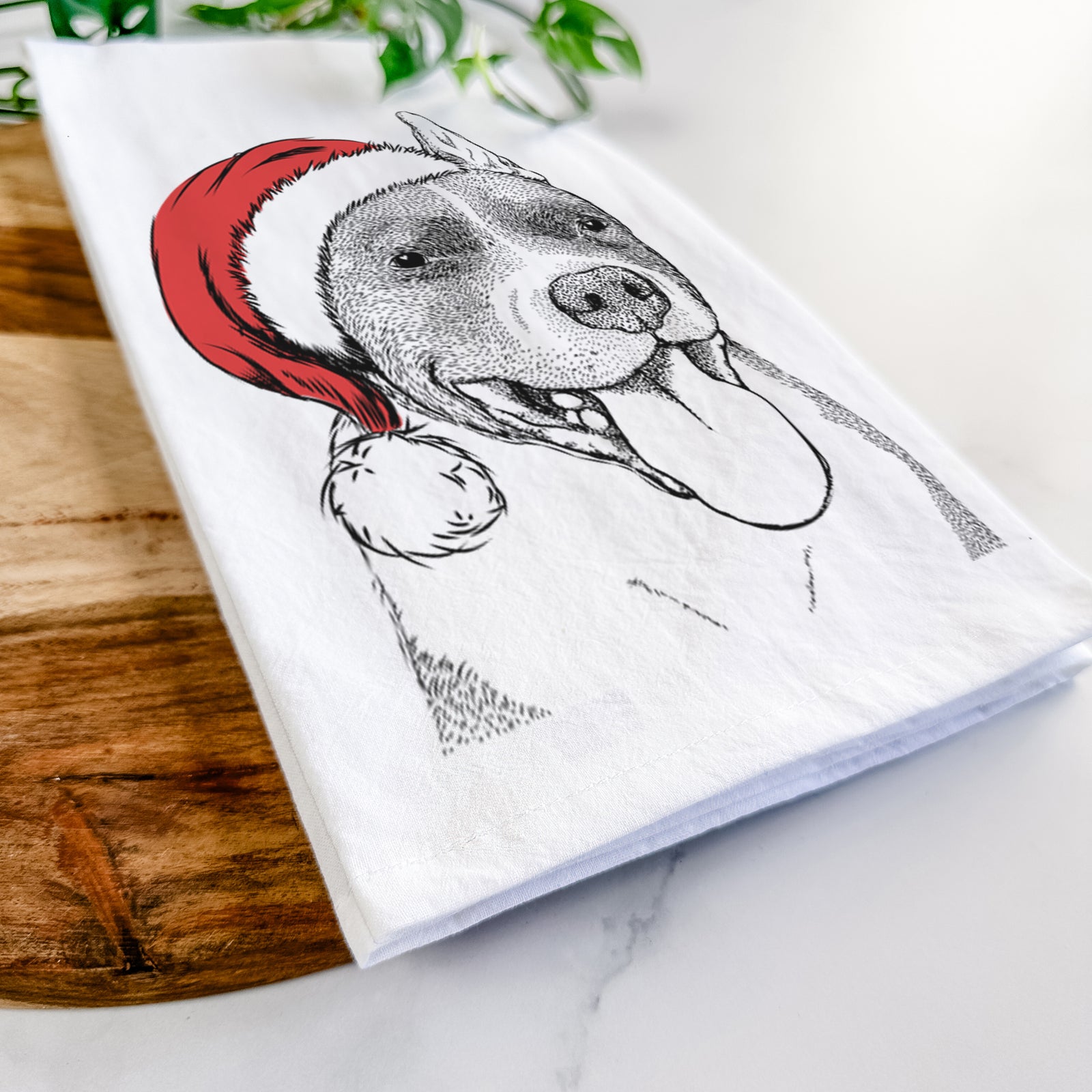 Hand-drawn sketch of Piggy the American Staffordshire Terrier wearing a Santa hat on a tea towel