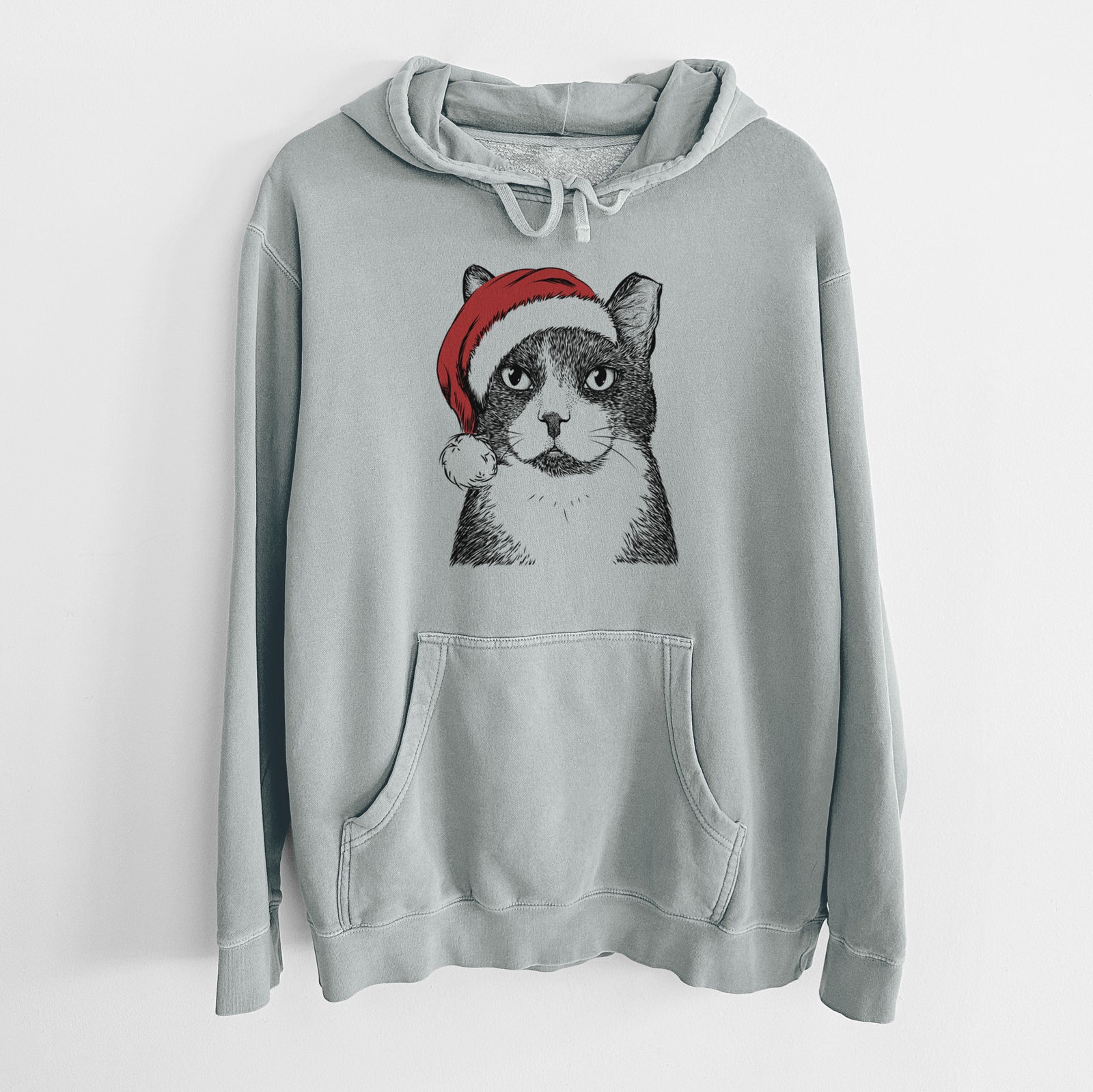 Hand-drawn sketch of Pinky the Tuxedo Cat wearing a Santa hat on a Sage Unisex pigment dyed hoodie