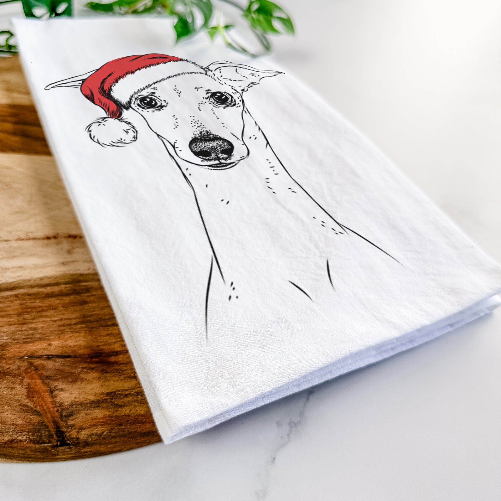 Hand-drawn sketch of Pip the Italian Greyhound wearing a Santa hat on a tea towel