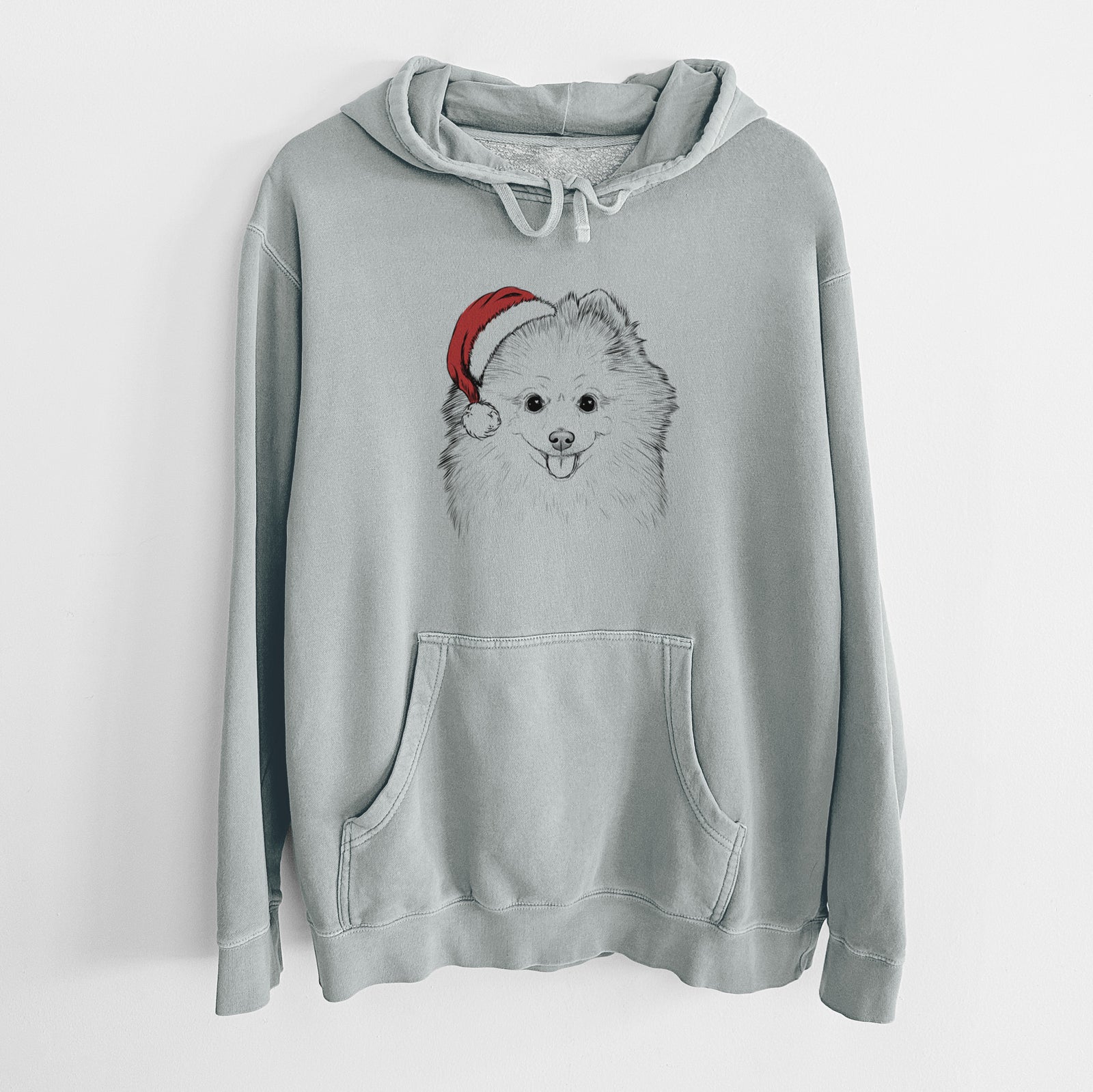 Hand-drawn sketch of Piper Jo the Pomeranian wearing a Santa hat on a Sage Unisex pigment dyed hoodie