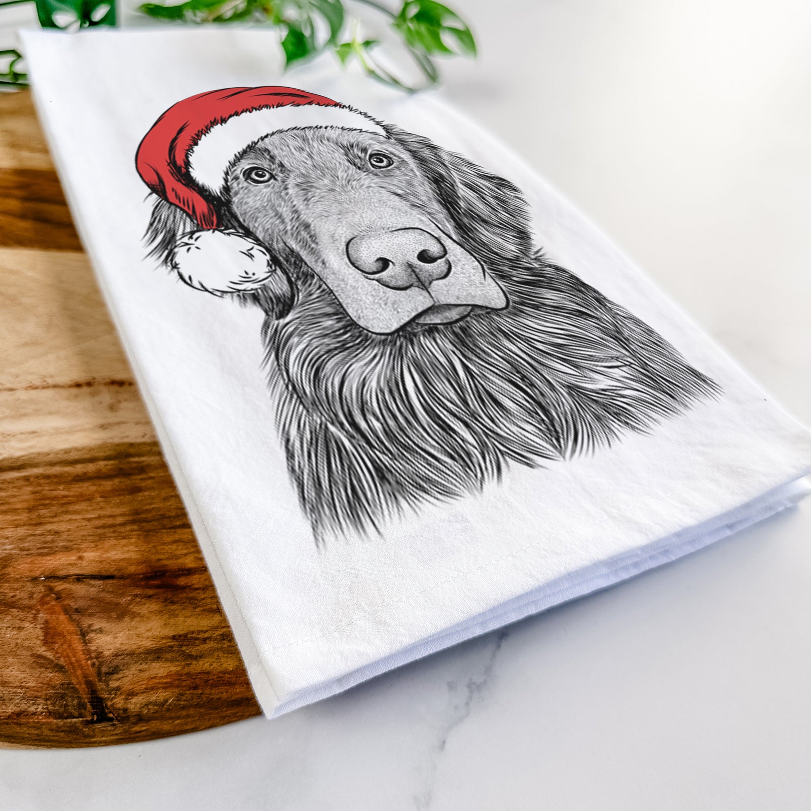 Hand-drawn sketch of Pippin the Flat Coated Retriever wearing a Santa hat on a tea towel