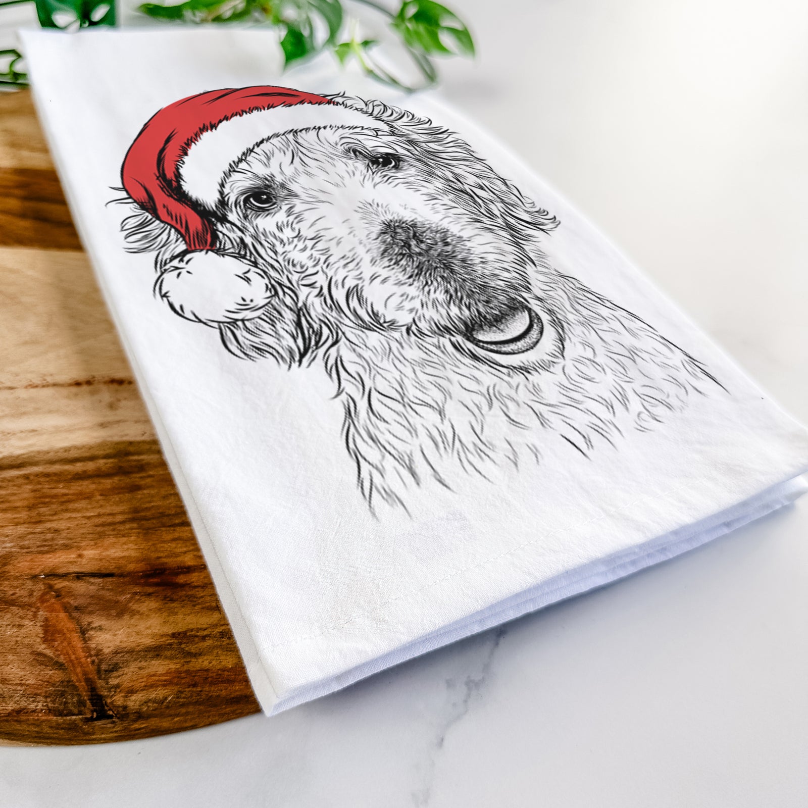 Hand-drawn sketch of Preston the Labradoodle wearing a Santa hat on a tea towel