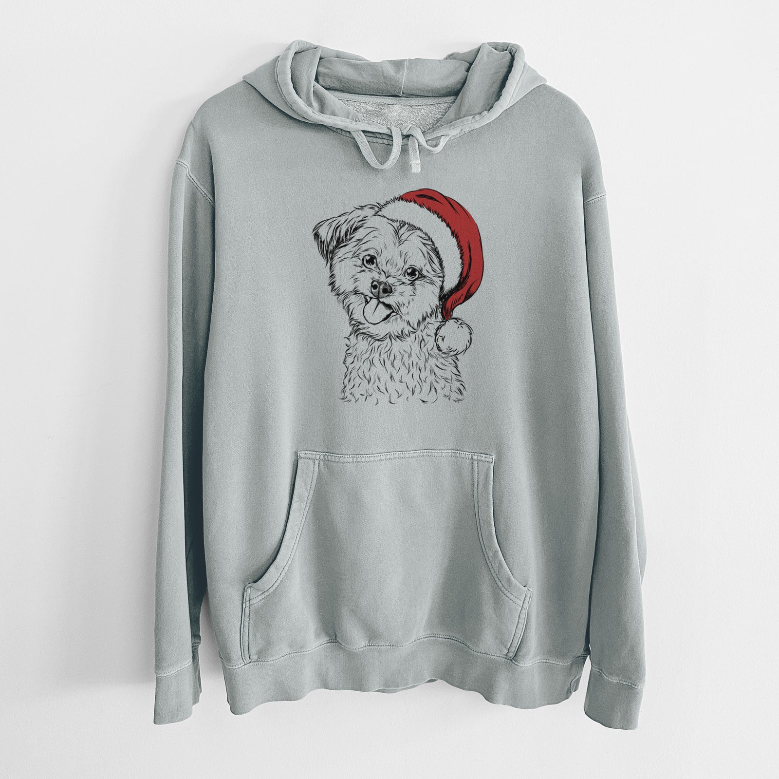 Hand-drawn sketch of Puff the Malshi wearing a Santa hat on a Sage Unisex pigment dyed hoodie