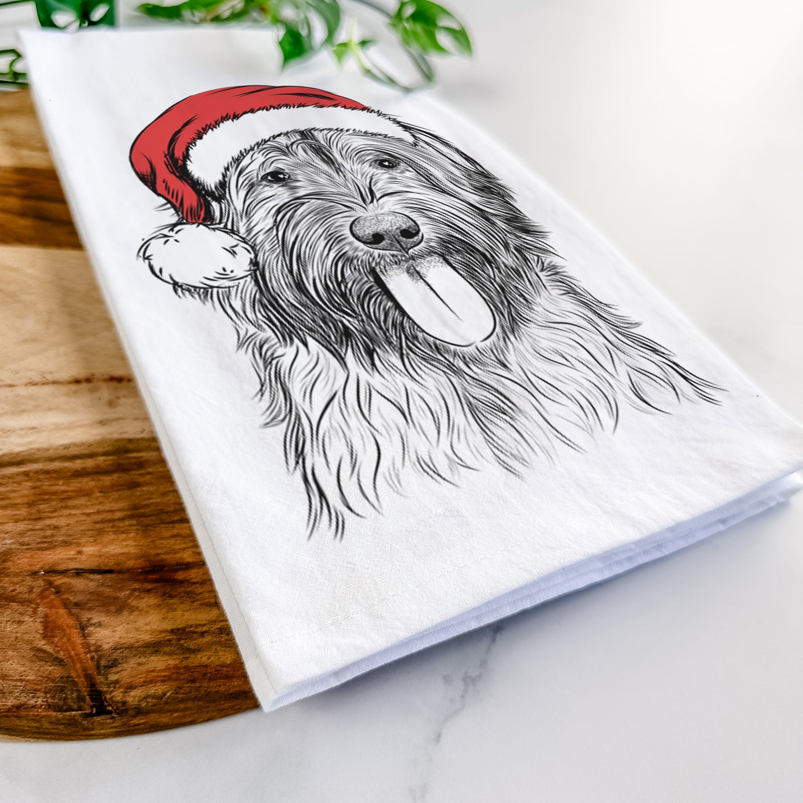 Hand-drawn sketch of Puig the Catalan Sheepdog wearing a Santa hat on a tea towel