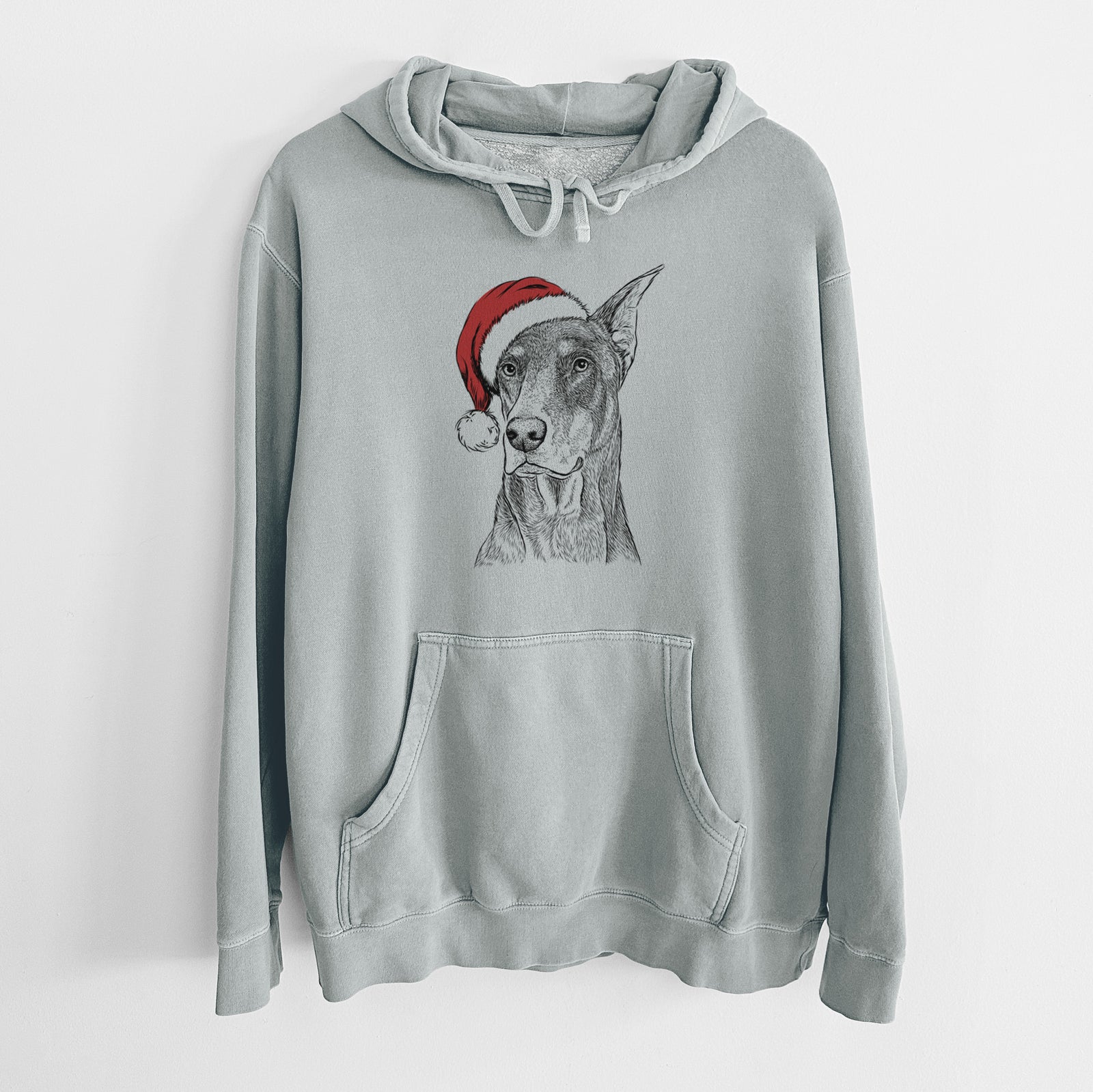 Hand-drawn sketch of RJ the Doberman Pinscher wearing a Santa hat on a Sage Unisex pigment dyed hoodie