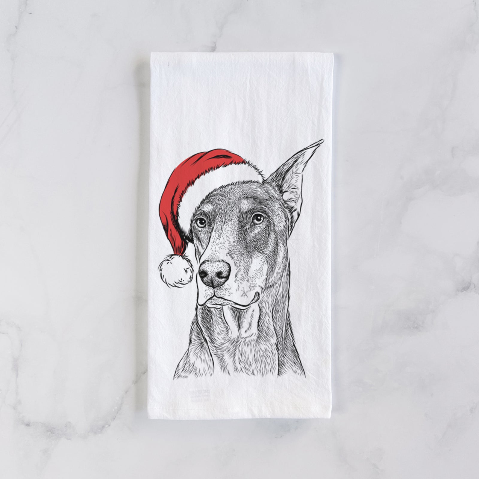 Hand-drawn sketch of RJ the Doberman Pinscher wearing a Santa hat on a tea towel